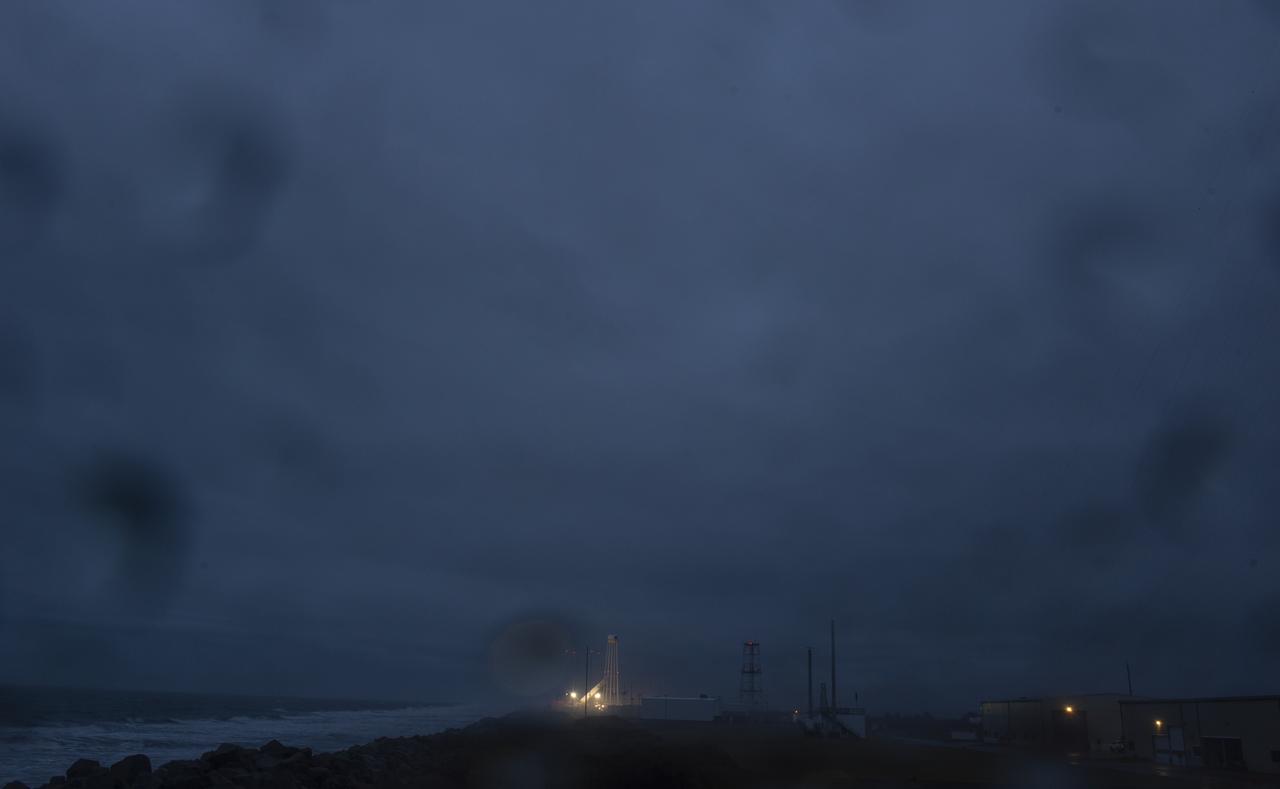 Pad-0A is seen illuminated by lights as work continues to raise the Northrop Grumman Antares rocket into a vertical position on the launch pad, Tuesday, Nov. 13, 2018 at NASA's Wallops Flight Facility in Virginia. Northrop Grumman's 10th contracted cargo resupply mission for NASA to the International Space Station will deliver about 7,500 pounds of science and research, crew supplies and vehicle hardware to the orbital laboratory and its crew. Launch is scheduled for Nov. 15 at 4:49 a.m. EST. Photo Credit: (NASA/Joel Kowsky)