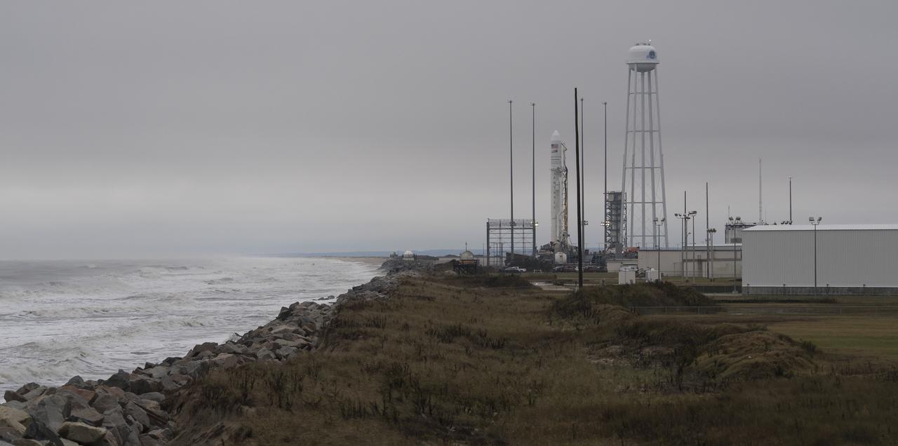 A Northrop Grumman Antares rocket carrying a Cygnus resupply spacecraft is seen on Pad-0A after being raised into a vertical position, Tuesday, Nov. 13, 2018 at NASA's Wallops Flight Facility in Virginia. Northrop Grumman's 10th contracted cargo resupply mission for NASA to the International Space Station will deliver about 7,500 pounds of science and research, crew supplies and vehicle hardware to the orbital laboratory and its crew. Launch is scheduled for Nov. 15 at 4:49 a.m. EST. Photo Credit: (NASA/Joel Kowsky)