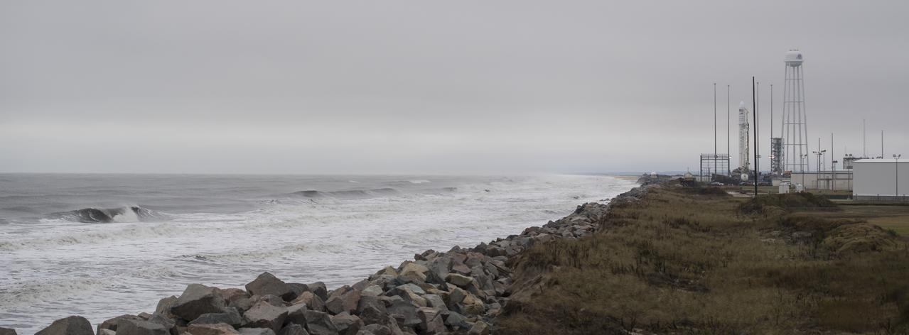 A Northrop Grumman Antares rocket carrying a Cygnus resupply spacecraft is seen on Pad-0A after being raised into a vertical position, Tuesday, Nov. 13, 2018 at NASA's Wallops Flight Facility in Virginia. Northrop Grumman's 10th contracted cargo resupply mission for NASA to the International Space Station will deliver about 7,500 pounds of science and research, crew supplies and vehicle hardware to the orbital laboratory and its crew. Launch is scheduled for Nov. 15 at 4:49 a.m. EST. Photo Credit: (NASA/Joel Kowsky)
