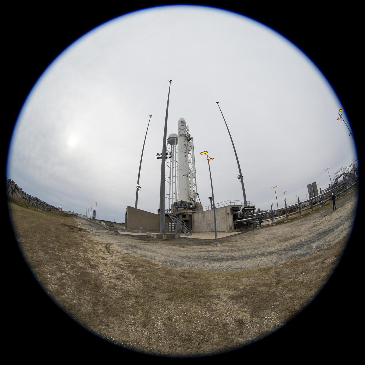 In this image taken with a circular fisheye lens, the Northrop Grumman Antares rocket, with Cygnus resupply spacecraft onboard, is seen on Pad-0A, Wednesday, Nov. 14, 2018 at NASA's Wallops Flight Facility in Virginia. Northrop Grumman's 10th contracted cargo resupply mission for NASA to the International Space Station will deliver about 7,400 pounds of science and research, crew supplies and vehicle hardware to the orbital laboratory and its crew. Launch is currently scheduled for Nov. 16 at 4:23 a.m. EST. Photo Credit: (NASA/Joel Kowsky)