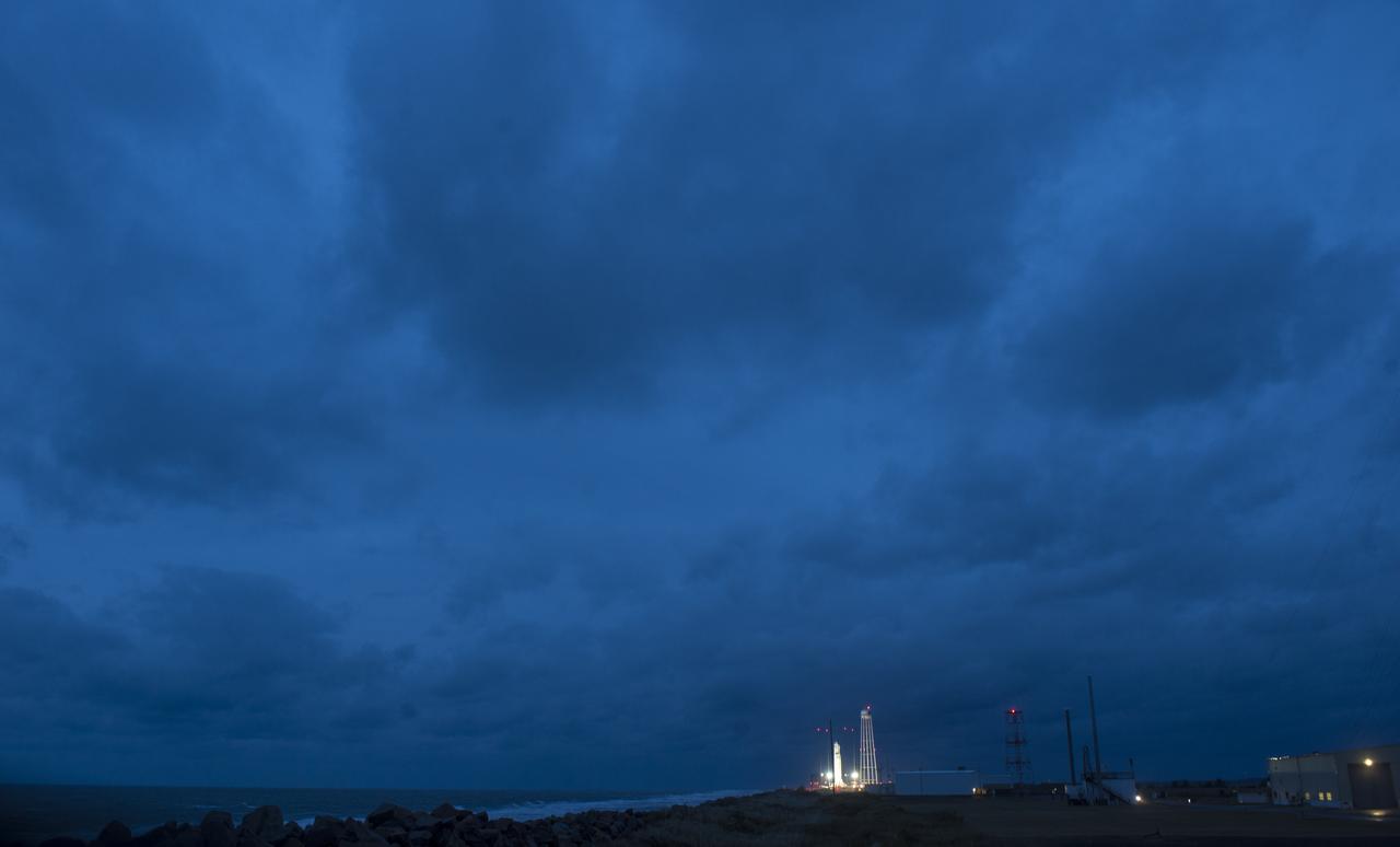 The Northrop Grumman Antares rocket, with Cygnus resupply spacecraft onboard, is seen on Pad-0A just before sunrise, Thursday, Nov. 15, 2018 at NASA's Wallops Flight Facility in Virginia. Northrop Grumman's 10th contracted cargo resupply mission for NASA to the International Space Station will deliver about 7,400 pounds of science and research, crew supplies and vehicle hardware to the orbital laboratory and its crew. Launch is currently scheduled for Friday, Nov. 16 at 4:23 a.m. EST. Photo Credit: (NASA/Joel Kowsky)