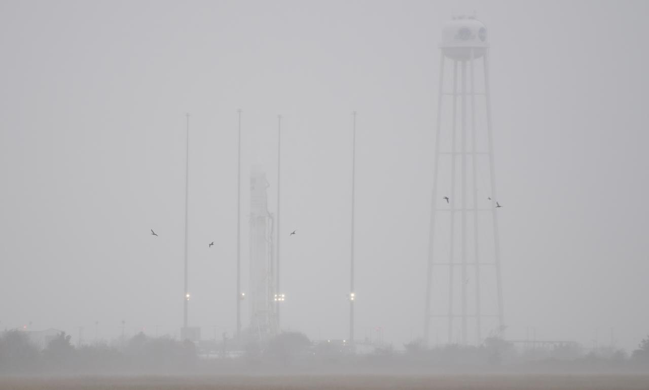 The Northrop Grumman Antares rocket, with Cygnus resupply spacecraft onboard, is seen on Pad-0A as rain and high winds move through the area, Thursday, Nov. 15, 2018 at NASA's Wallops Flight Facility in Virginia. Northrop Grumman's 10th contracted cargo resupply mission for NASA to the International Space Station will deliver about 7,400 pounds of science and research, crew supplies and vehicle hardware to the orbital laboratory and its crew. Launch is currently targeted for Saturday, Nov. 17 at 4:01 a.m. EST. Photo Credit: (NASA/Joel Kowsky)
