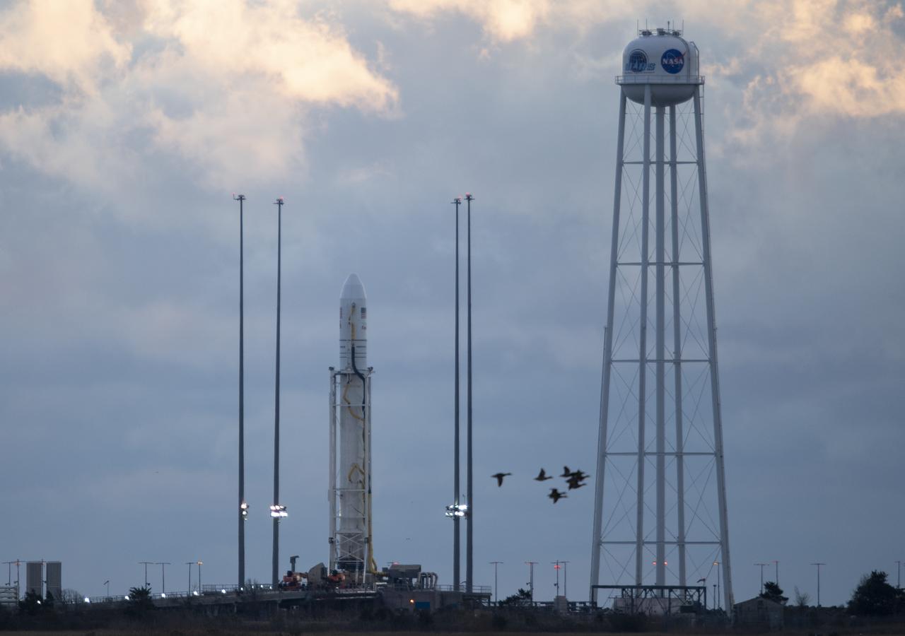 The Northrop Grumman Antares rocket, with Cygnus resupply spacecraft onboard, is seen on Pad-0A at sunrise, Friday, Nov. 16, 2018 at NASA's Wallops Flight Facility in Virginia. Northrop Grumman's 10th contracted cargo resupply mission for NASA to the International Space Station will deliver about 7,400 pounds of science and research, crew supplies and vehicle hardware to the orbital laboratory and its crew. Launch is currently scheduled for Saturday, Nov. 17 at 4:01 a.m. EST. Photo Credit: (NASA/Joel Kowsky)