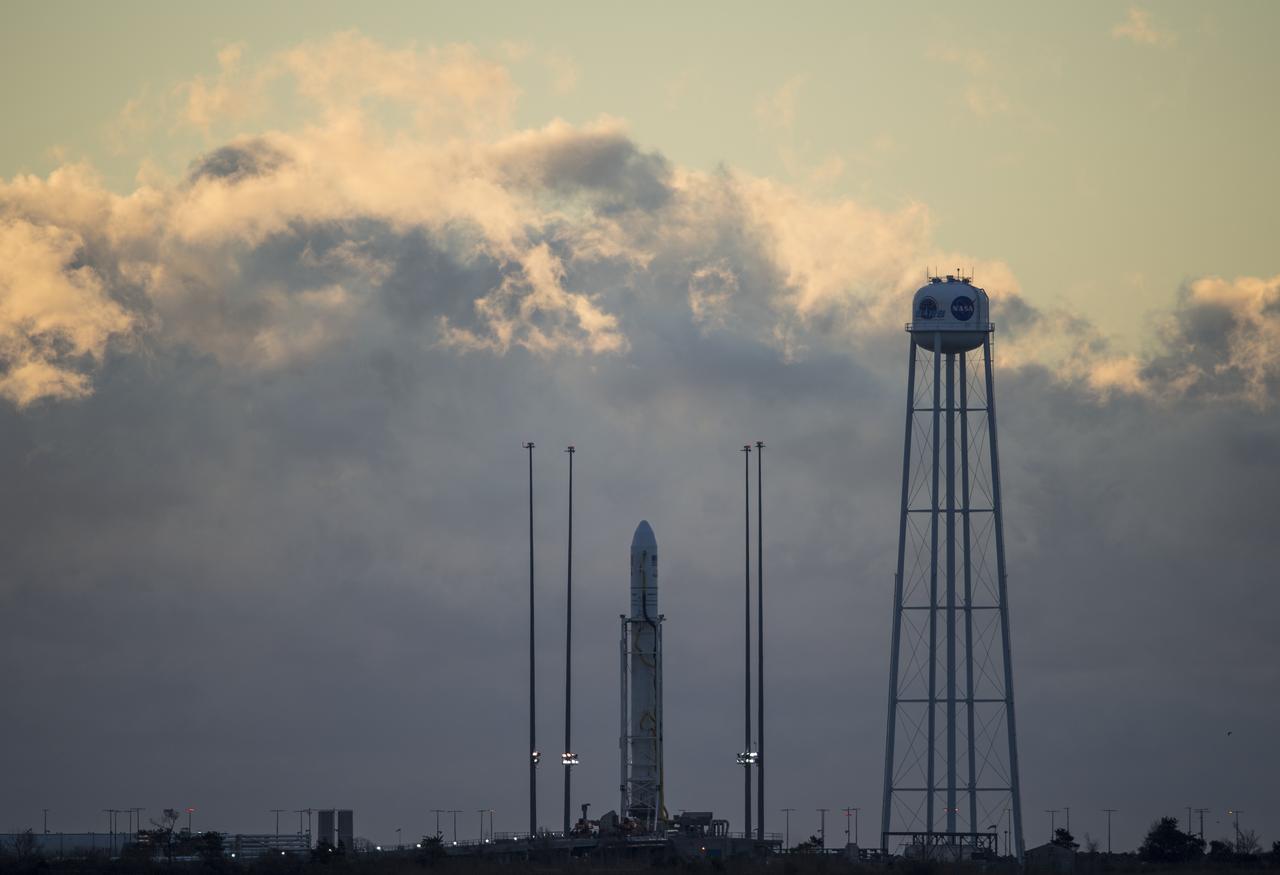 The Northrop Grumman Antares rocket, with Cygnus resupply spacecraft onboard, is seen on Pad-0A at sunrise, Friday, Nov. 16, 2018 at NASA's Wallops Flight Facility in Virginia. Northrop Grumman's 10th contracted cargo resupply mission for NASA to the International Space Station will deliver about 7,400 pounds of science and research, crew supplies and vehicle hardware to the orbital laboratory and its crew. Launch is currently scheduled for Saturday, Nov. 17 at 4:01 a.m. EST. Photo Credit: (NASA/Joel Kowsky)