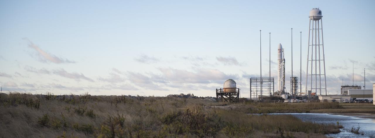 The Northrop Grumman Antares rocket, with Cygnus resupply spacecraft onboard, is seen on Pad-0A after sunrise, Friday, Nov. 16, 2018 at NASA's Wallops Flight Facility in Virginia. Northrop Grumman's 10th contracted cargo resupply mission for NASA to the International Space Station will deliver about 7,400 pounds of science and research, crew supplies and vehicle hardware to the orbital laboratory and its crew. Launch is currently scheduled for Saturday, Nov. 17 at 4:01 a.m. EST. Photo Credit: (NASA/Joel Kowsky)