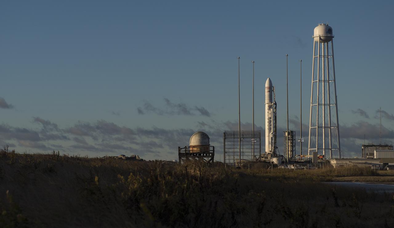The Northrop Grumman Antares rocket, with Cygnus resupply spacecraft onboard, is seen on Pad-0A after sunrise, Friday, Nov. 16, 2018 at NASA's Wallops Flight Facility in Virginia. Northrop Grumman's 10th contracted cargo resupply mission for NASA to the International Space Station will deliver about 7,400 pounds of science and research, crew supplies and vehicle hardware to the orbital laboratory and its crew. Launch is currently scheduled for Saturday, Nov. 17 at 4:01 a.m. EST. Photo Credit: (NASA/Joel Kowsky)
