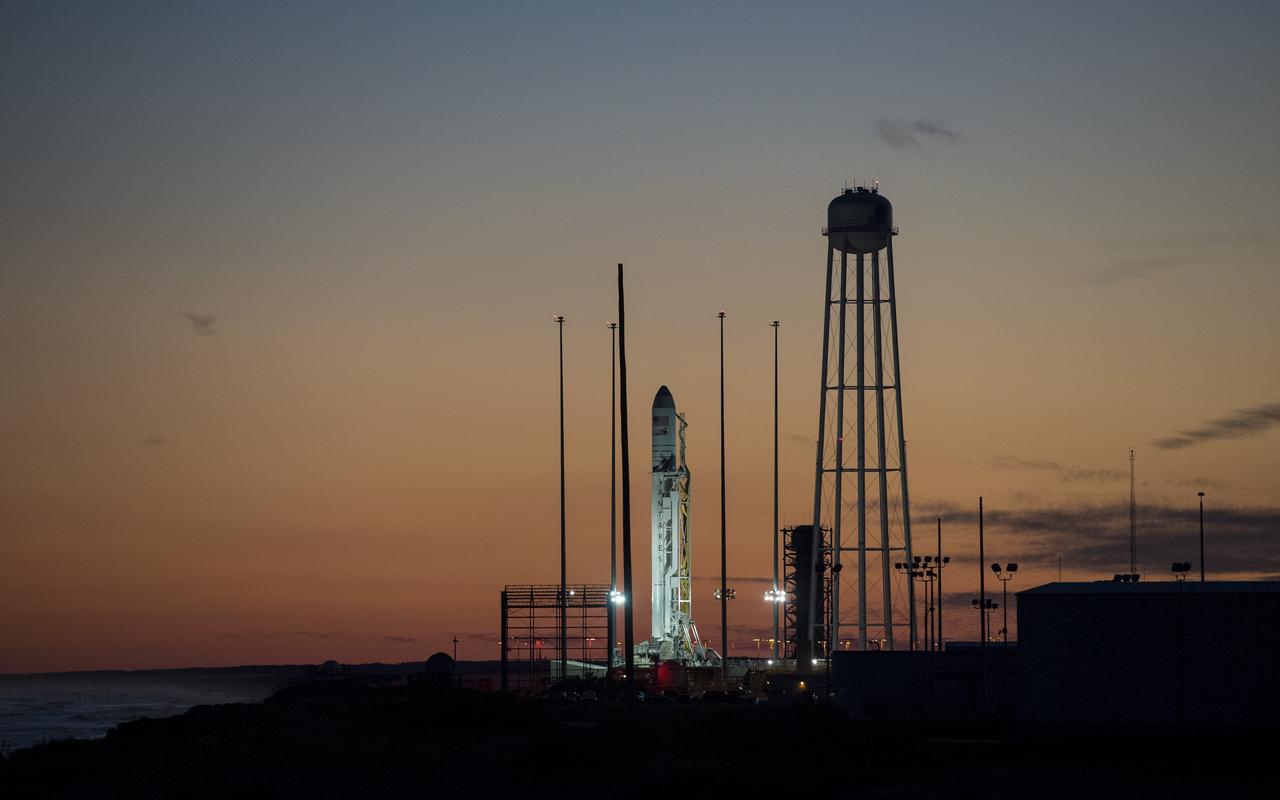 The Northrop Grumman Antares rocket, with Cygnus resupply spacecraft onboard, is seen on Pad-0A at sunset, Friday, Nov. 16, 2018 at NASA's Wallops Flight Facility in Virginia. Northrop Grumman's 10th contracted cargo resupply mission for NASA to the International Space Station will deliver about 7,400 pounds of science and research, crew supplies and vehicle hardware to the orbital laboratory and its crew. Launch is currently scheduled for Saturday, Nov. 17 at 4:01 a.m. EST. Photo Credit: (NASA/Joel Kowsky)