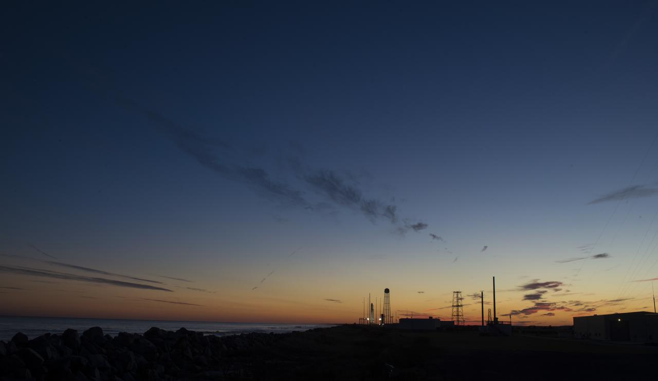 The Northrop Grumman Antares rocket, with Cygnus resupply spacecraft onboard, is seen on Pad-0A at sunset, Friday, Nov. 16, 2018 at NASA's Wallops Flight Facility in Virginia. Northrop Grumman's 10th contracted cargo resupply mission for NASA to the International Space Station will deliver about 7,400 pounds of science and research, crew supplies and vehicle hardware to the orbital laboratory and its crew. Launch is currently scheduled for Nov. 17 at 4:01 a.m. EST. Photo Credit: (NASA/Joel Kowsky)