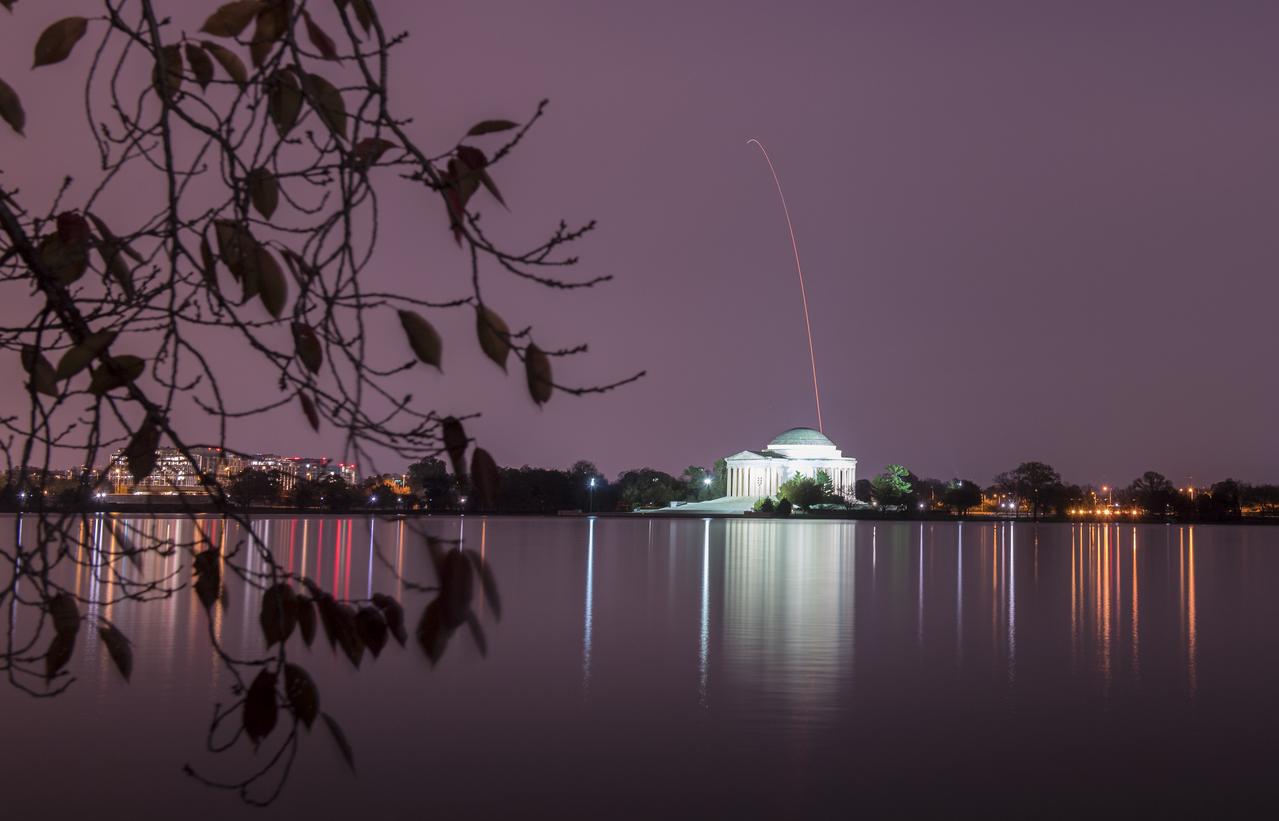 The Northrop Grumman Antares rocket, with Cygnus resupply spacecraft onboard, is seen above the Thomas Jefferson Memorial in this long exposure, as it launches from Pad-0A, Saturday, Nov. 17, 2018 at NASA's Wallops Flight Facility in Virginia. Northrop Grumman's 10th contracted cargo resupply mission for NASA to the International Space Station will deliver about 7,400 pounds of science and research, crew supplies and vehicle hardware to the orbital laboratory and its crew. Photo Credit: (NASA/Aubrey Gemignani)