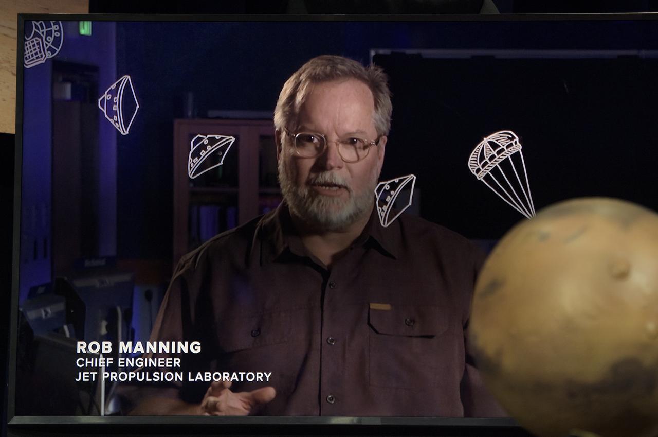 Jet Propulsion Laboratory Chief Engineer Rob Manning is seen in a video shown during a Mars InSight social media briefing, Sunday, Nov. 25, 2018 at NASA's Jet Propulsion Laboratory in Pasadena, California.  InSight, short for Interior Exploration using Seismic Investigations, Geodesy and Heat Transport, is a Mars lander designed to study the "inner space" of Mars: its crust, mantle, and core. InSight is scheduled to touch down on the Red Planet at approximately noon PST (3 p.m. EST) on Nov. 26. Photo Credit: (NASA/Bill Ingalls)