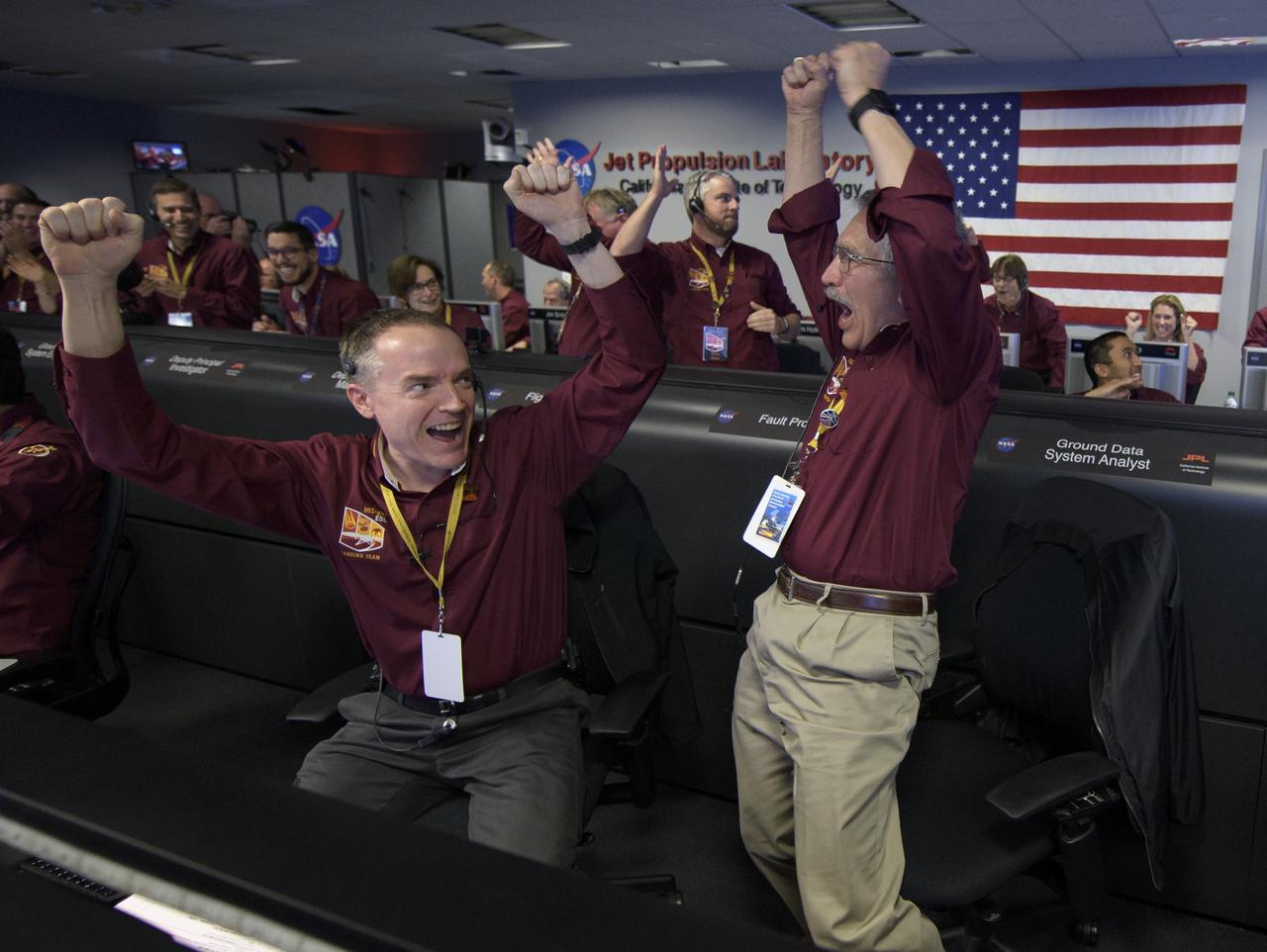 Mars InSight team members Kris Bruvold, left, and Sandy Krasner react after receiving confirmation that the Mars InSight lander successfully touched down on the surface of Mars, Monday, Nov. 26, 2018 inside the Mission Support Area at NASA's Jet Propulsion Laboratory in Pasadena, California.  InSight, short for Interior Exploration using Seismic Investigations, Geodesy and Heat Transport, is a Mars lander designed to study the "inner space" of Mars: its crust, mantle, and core. Photo Credit: (NASA/Bill Ingalls)