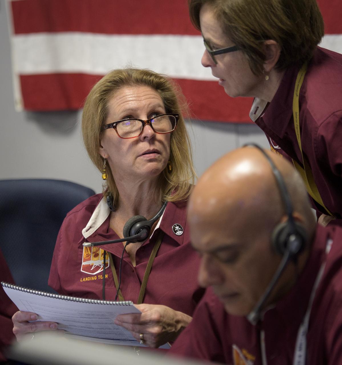 NASA Headquarters acting director of the Planetary Science Division Lori Glaze, left, talks with Sue Smrekar, InSight deputy principal investigator, NASA JPL, as they and other Mars InSight team members monitor the status of the lander prior to it touching down on Mars, Monday, Nov. 26, 2018 inside the Mission Support Area at NASA's Jet Propulsion Laboratory in Pasadena, California.  InSight, short for Interior Exploration using Seismic Investigations, Geodesy and Heat Transport, is a Mars lander designed to study the "inner space" of Mars: its crust, mantle, and core. Photo Credit: (NASA/Bill Ingalls)