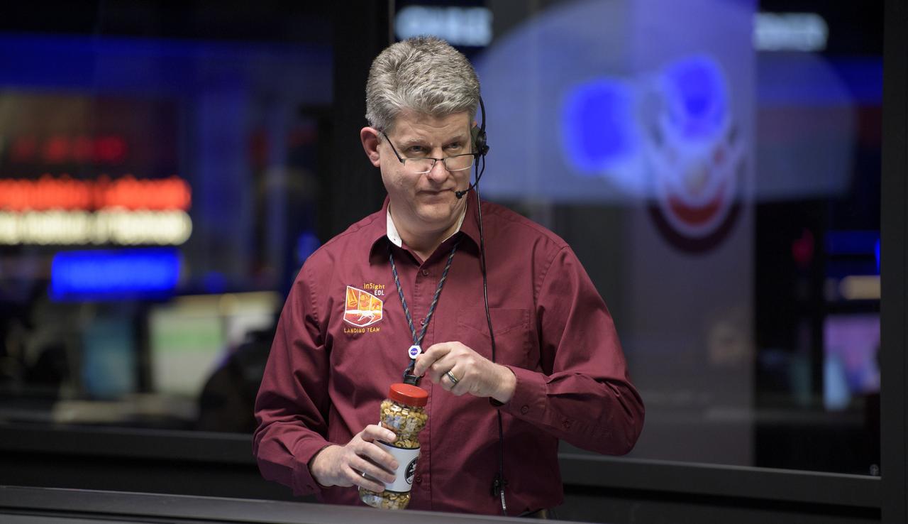 Rob Grover, EDL Phase Lead, NASA JPL, holds a jar of good-luck peanuts as he and other Mars InSight team members monitor the status of the lander prior to it touching down on Mars, Monday, Nov. 26, 2018 inside the Mission Support Area at NASA's Jet Propulsion Laboratory in Pasadena, California. InSight, short for Interior Exploration using Seismic Investigations, Geodesy and Heat Transport, is a Mars lander designed to study the "inner space" of Mars: its crust, mantle, and core. Photo Credit: (NASA/Bill Ingalls)