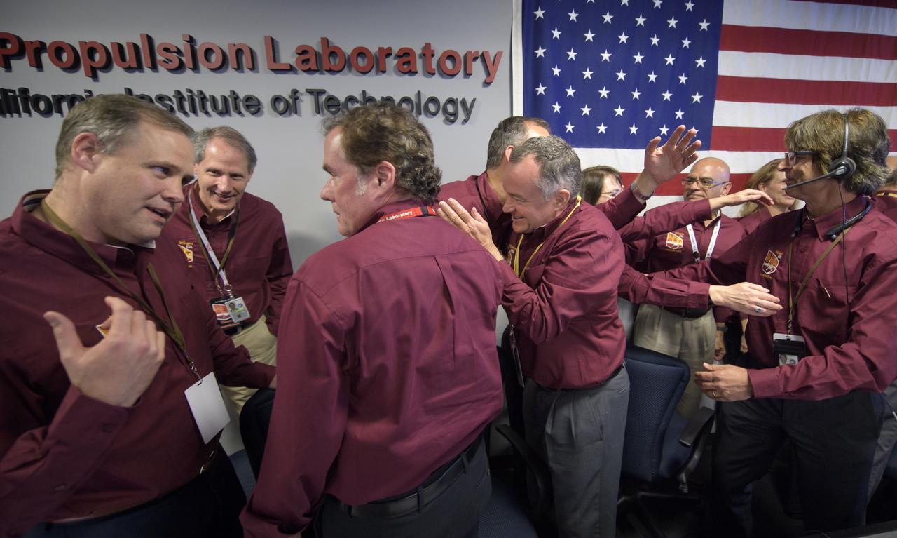 NASA Administrator Jim Bridenstine, left, celebrates with other managers after receiving confirmation that the Mars InSight lander successfully touched down on the surface of Mars, Monday, Nov. 26, 2018 inside the Mission Support Area at NASA's Jet Propulsion Laboratory in Pasadena, California. InSight, short for Interior Exploration using Seismic Investigations, Geodesy and Heat Transport, is a Mars lander designed to study the "inner space" of Mars: its crust, mantle, and core. Photo Credit: (NASA/Bill Ingalls)