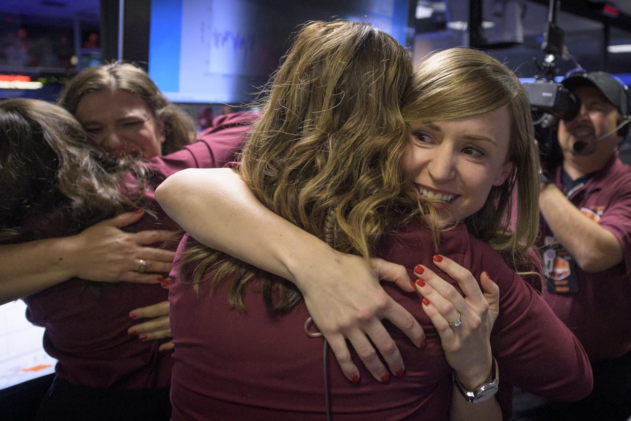 Julie Wertz-Chen, Entry, Descent and Landing systems engineer, NASA JPL, left, and Aline Zimmer, Systems Engineer, NASA JPL, right hug their colleagues after receiving confirmation that the Mars InSight lander successfully touched down on the surface of Mars, Monday, Nov. 26, 2018 inside the Mission Support Area at NASA's Jet Propulsion Laboratory in Pasadena, California.  InSight, short for Interior Exploration using Seismic Investigations, Geodesy and Heat Transport, is a Mars lander designed to study the "inner space" of Mars: its crust, mantle, and core. Photo Credit: (NASA/Bill Ingalls)