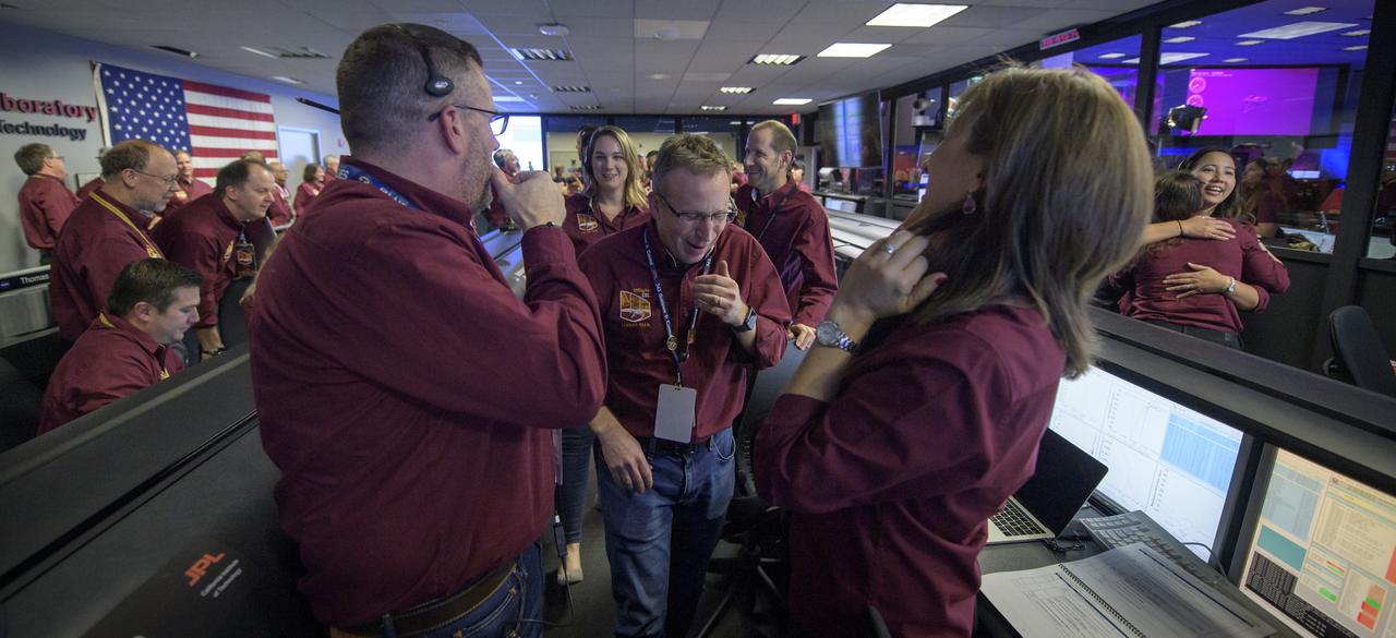 Mars InSight team members all react after receiving confirmation that the Mars InSight lander successfully touched down on the surface of Mars, Monday, Nov. 26, 2018 inside the Mission Support Area at NASA's Jet Propulsion Laboratory in Pasadena, California. InSight, short for Interior Exploration using Seismic Investigations, Geodesy and Heat Transport, is a Mars lander designed to study the "inner space" of Mars: its crust, mantle, and core. Photo Credit: (NASA/Bill Ingalls)