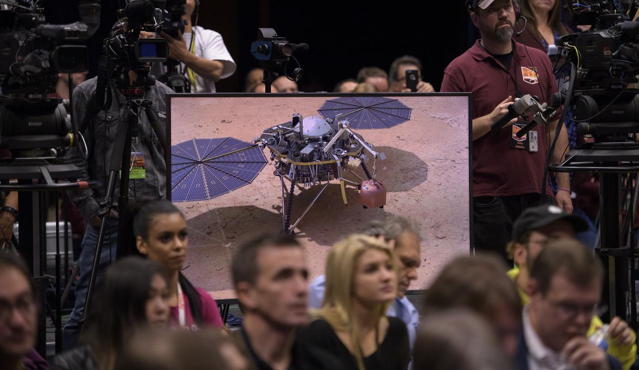 Animation showing the placement of the Mars InSight instruments is played during a post-landing press conference, Monday, Nov. 26, 2018 at NASA's Jet Propulsion Laboratory in Pasadena, California. InSight, short for Interior Exploration using Seismic Investigations, Geodesy and Heat Transport, is a Mars lander designed to study the "inner space" of Mars: its crust, mantle, and core. Photo Credit: (NASA/Bill Ingalls)