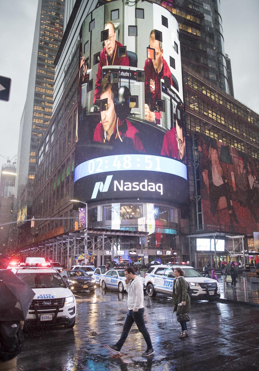 The live NASA TV broadcast from inside the Mission Support Area of NASA's Jet Propulsion Laboratory is seen on the video board of the Nasdaq MarketSite as NASA's InSight lander begins its descent towards the surface of Mars, Monday, Nov. 26, 2018 in Times Square in New York City. The lander sent a signal affirming a completed landing sequence at approximately 3 p.m. EST (noon PST) after touching down on the western side of a flat, smooth expanse of lava called Elysium Planitila. InSight, short for Interior Exploration using Seismic Investigations, Geodesy and Heat Transport, is a Mars lander designed to study the "inner space" of Mars: its crust, mantle, and core. Photo Credit: (NASA/Joel Kowsky)