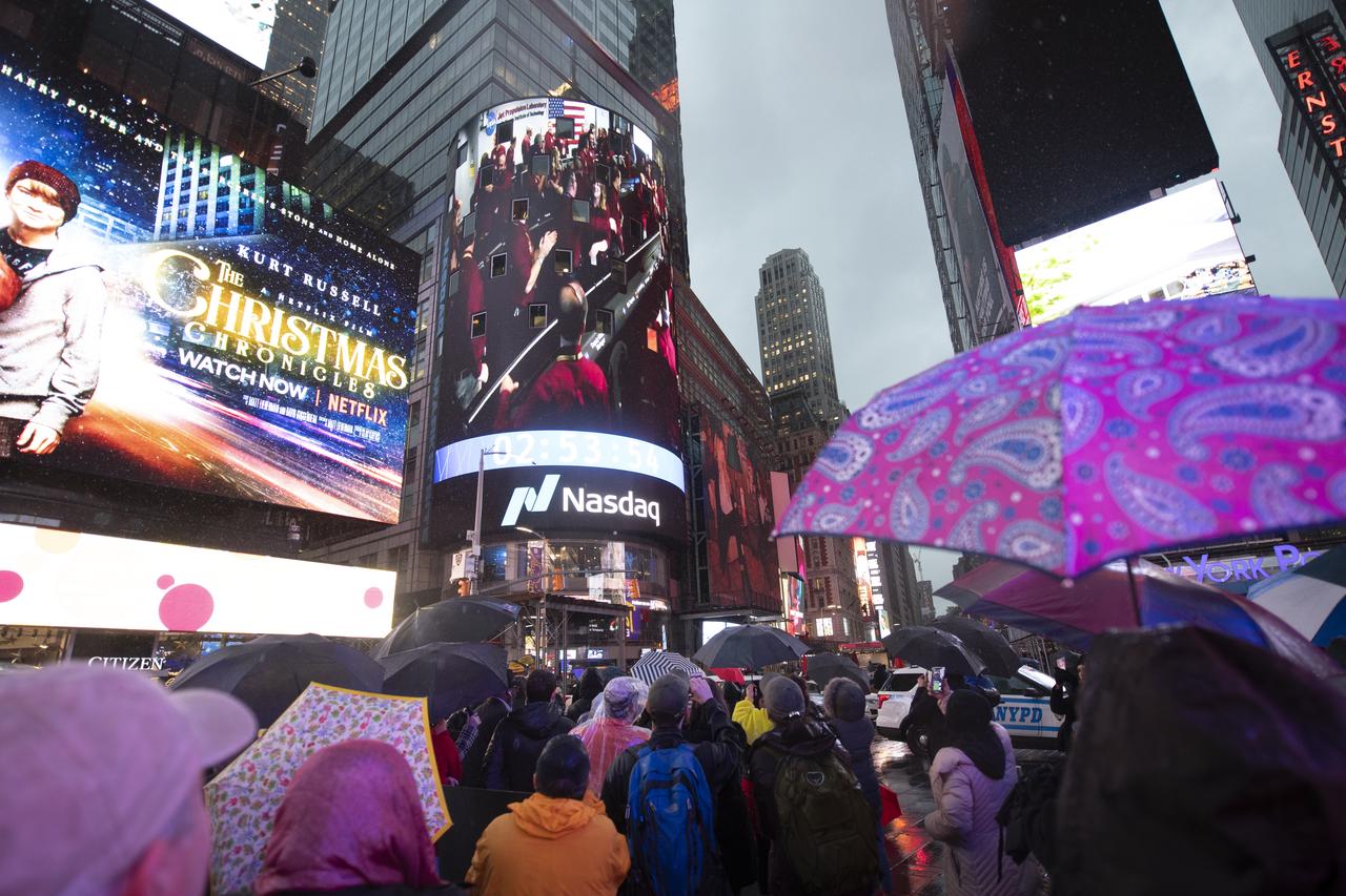 Spectators in Times Square watch the video board of the Nasdaq MarketSite showing the live NASA TV broadcast as NASA InSight team members celebrate inside the Mission Support Area of NASA's Jet Propulsion Laboratory after receiving confirmation the lander successfully touched down on the surface of Mars, Monday, Nov. 26, 2018 in Times Square in New York City. The lander sent a signal affirming a completed landing sequence at approximately 3 p.m. EST (noon PST) after touching down on the western side of a flat, smooth expanse of lava called Elysium Planitila. InSight, short for Interior Exploration using Seismic Investigations, Geodesy and Heat Transport, is a Mars lander designed to study the "inner space" of Mars: its crust, mantle, and core. Photo Credit: (NASA/Joel Kowsky)