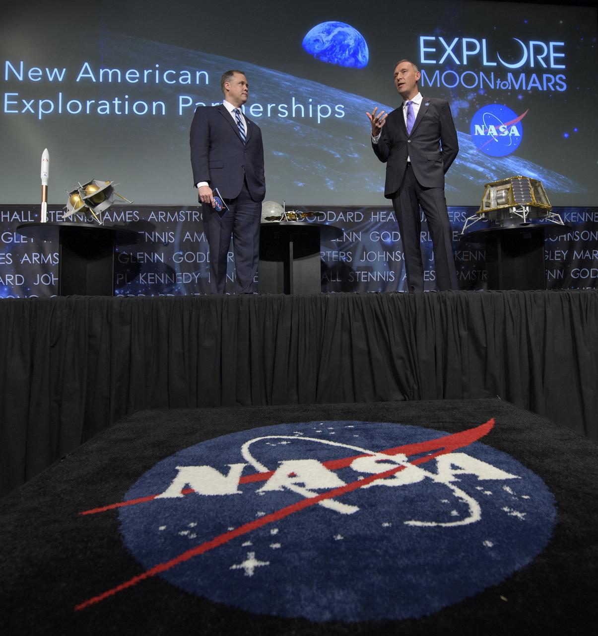 NASA Administrator Jim Bridenstine, left, and NASA Associate Administrator for the Science Mission Directorate, Thomas Zurbuchen, answer questions during an event where nine U.S. companies where named as eligible to bid on NASA delivery services to the lunar surface through Commercial Lunar Payload Services (CLPS) contracts, Thursday, Nov. 29, 2018 at NASA Headquarters in Washington. The companies will be able to bid on delivering science and technology payloads for NASA, including payload integration and operations, launching from Earth and landing on the surface of the Moon. NASA expects to be one of many customers that will use these commercial landing services. Photo Credit: (NASA/Bill Ingalls)