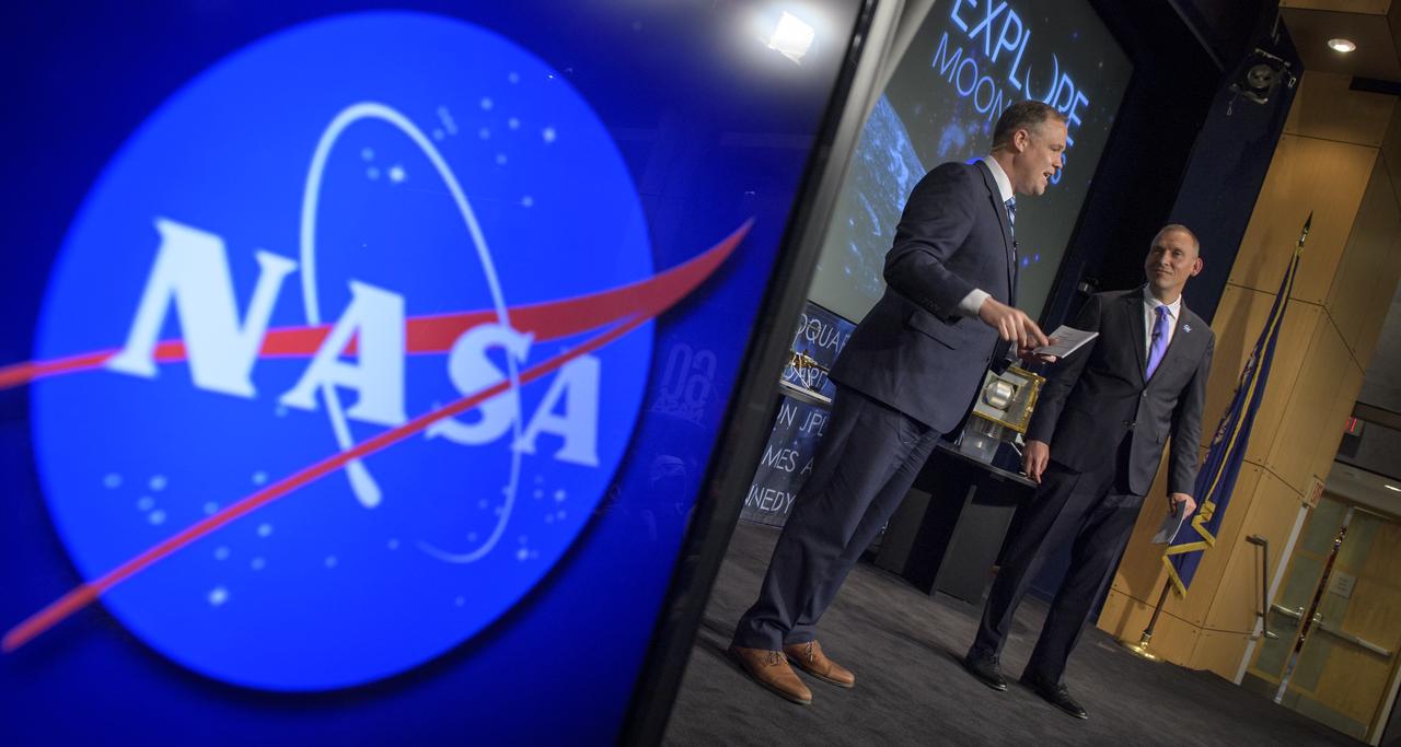 NASA Administrator Jim Bridenstine, left, and NASA Associate Administrator for the Science Mission Directorate, Thomas Zurbuchen, answer questions during an event where nine U.S. companies where named as eligible to bid on NASA delivery services to the lunar surface through Commercial Lunar Payload Services (CLPS) contracts, Thursday, Nov. 29, 2018 at NASA Headquarters in Washington. The companies will be able to bid on delivering science and technology payloads for NASA, including payload integration and operations, launching from Earth and landing on the surface of the Moon. NASA expects to be one of many customers that will use these commercial landing services. Photo Credit: (NASA/Bill Ingalls)