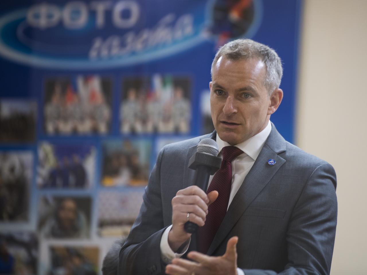 Expedition 58 Flight Engineer David Saint-Jacques of the Canadian Space Agency (CSA) speaks from behind glass, while in quarantine, during the State Commission meeting to approve the Soyuz launch of Expedition 58 to the International Space Station, Sunday, Dec. 2, 2018 at the Cosmonaut Hotel in Baikonur, Kazakhstan. Launch of the Soyuz rocket is scheduled for Dec. 3 and will carry Saint-Jacques, Soyuz Commander Oleg Kononenko of Roscosmos, and Flight Engineer Anne McClain of NASA into orbit to begin their six and a half month mission on the International Space Station. Photo Credit: (NASA/Aubrey Gemignani).