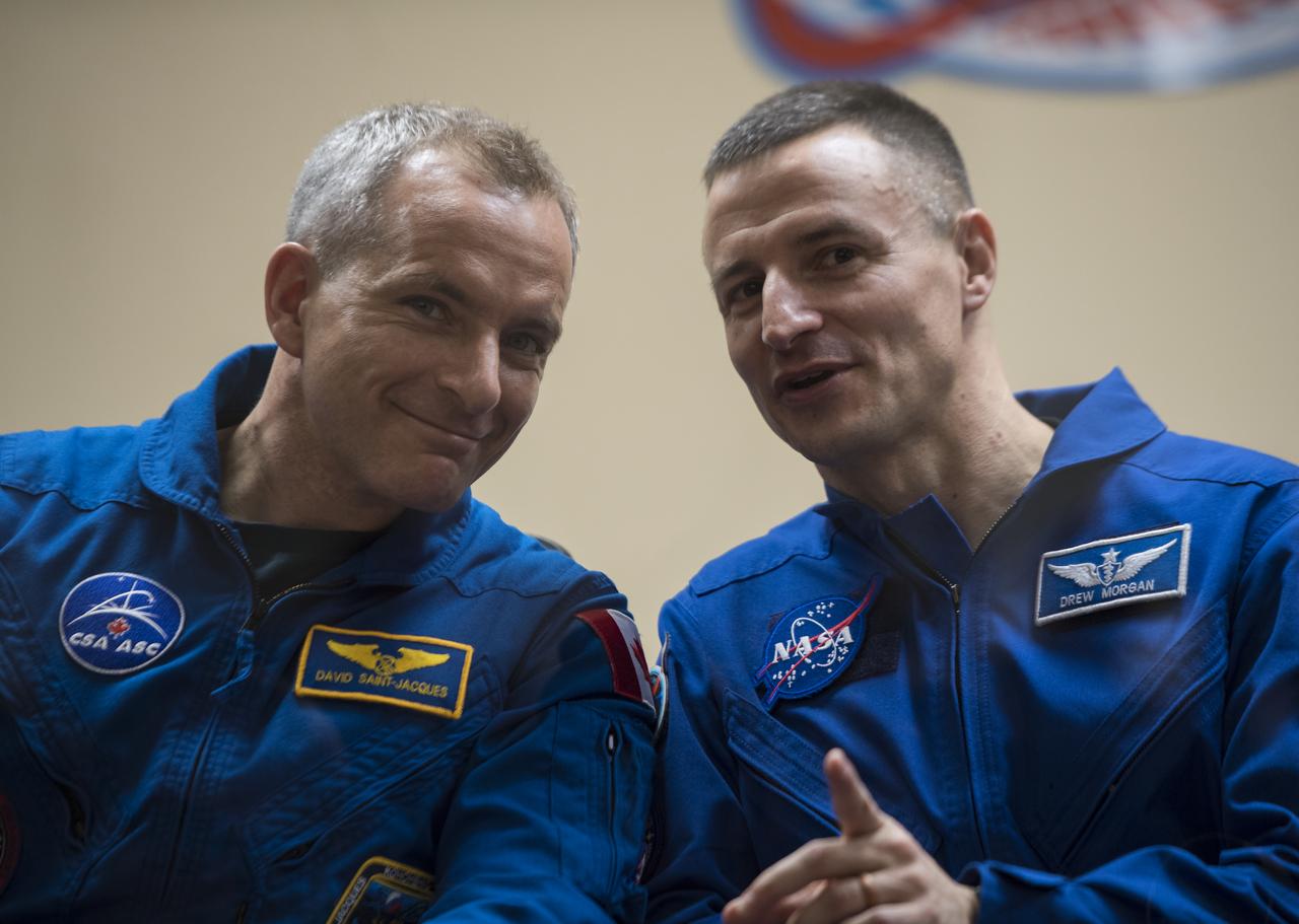 Expedition 58 Flight Engineer David Saint-Jacques of the Canadian Space Agency (CSA), left, and backup crew member Flight Engineer Andrew Morgan of NASA, speak during a press conference, Sunday, Dec. 2, 2018 at the Cosmonaut Hotel in Baikonur, Kazakhstan. Launch of the Soyuz rocket is scheduled for Dec. 3 and will carry Expedition 58 prime crew members, Saint-Jacques, Soyuz Commander Oleg Kononenko of Roscosmos, and Flight Engineer Anne McClain of NASA into orbit to begin their six and a half month mission on the International Space Station. Photo Credit: (NASA/Aubrey Gemignani).
