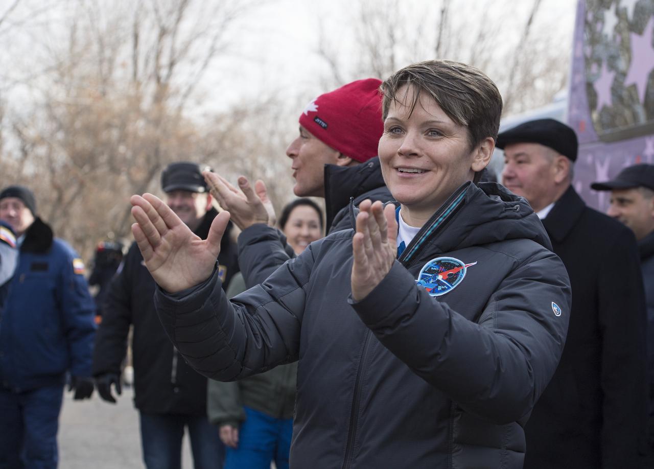 Expedition 58 Flight Engineer Anne McClain of NASA, greets family and friends as she departs the Cosmonaut Hotel to suit-up for her Soyuz launch to the International Space Station on Monday, Dec. 3, 2018 in Baikonur, Kazakhstan. Launch of the Soyuz rocket is Dec. 3 and will send McClain, Flight Engineer David Saint-Jacques of the Canadian Space Agency (CSA), and Soyuz Commander Oleg Kononenko of Roscosmos on a six and a half month mission aboard the International Space Station. Photo Credit: (NASA/Aubrey Gemignani)