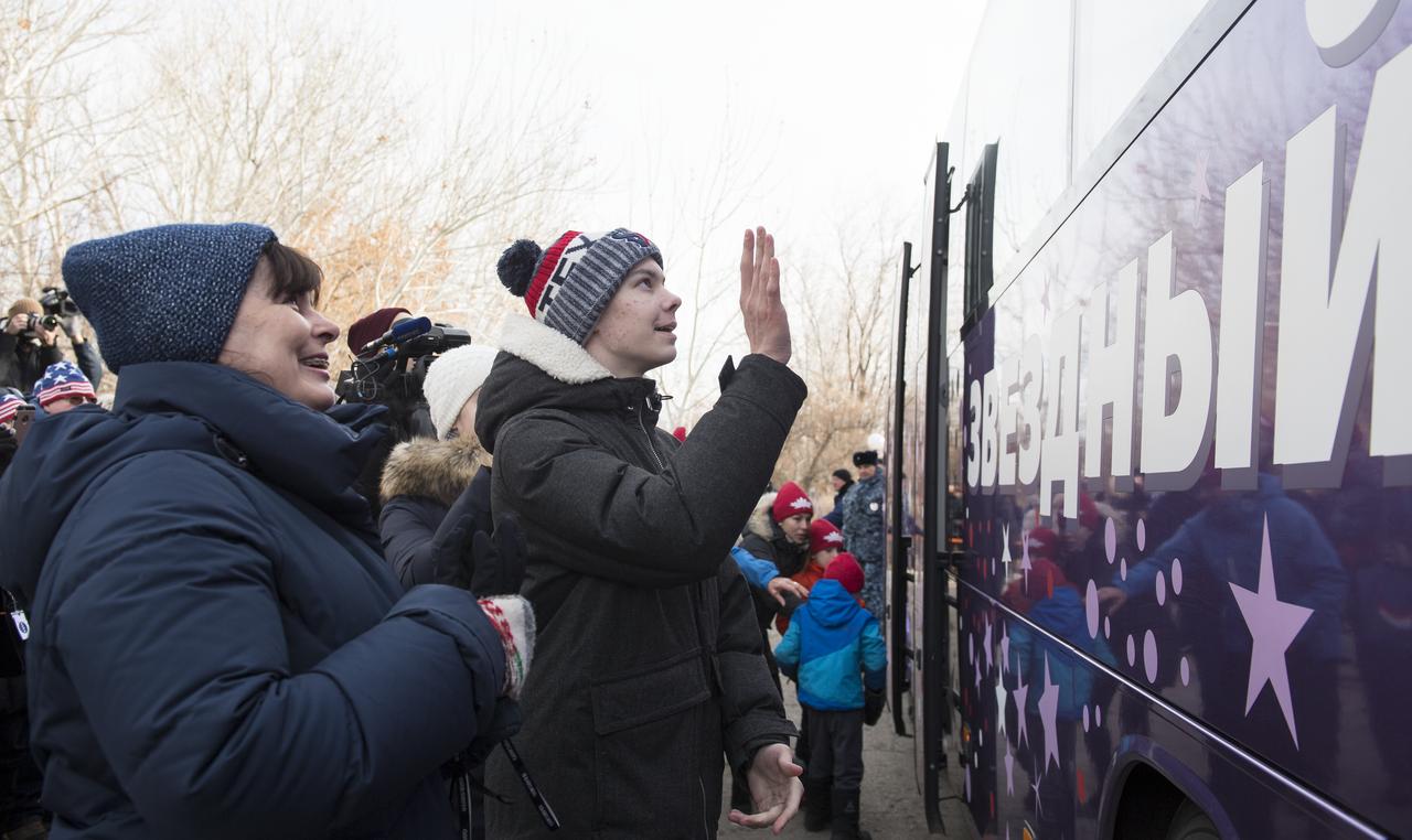 Family of Expedition 58 Soyuz Commander Oleg Kononenko of Roscosmos wave farewell as the Expedition 58 crew departs the Cosmonaut Hotel to suit-up for their Soyuz launch to the International Space Station on Monday, Dec. 3, 2018 in Baikonur, Kazakhstan. Launch of the Soyuz rocket is scheduled for the same day and will send Kononenko, Flight Engineer Anne McClain of NASA, and Flight Engineer David Saint-Jacques of the Canadian Space Agency (CSA) on a six and a half month mission aboard the International Space Station. Photo Credit: (NASA/Aubrey Gemignani)