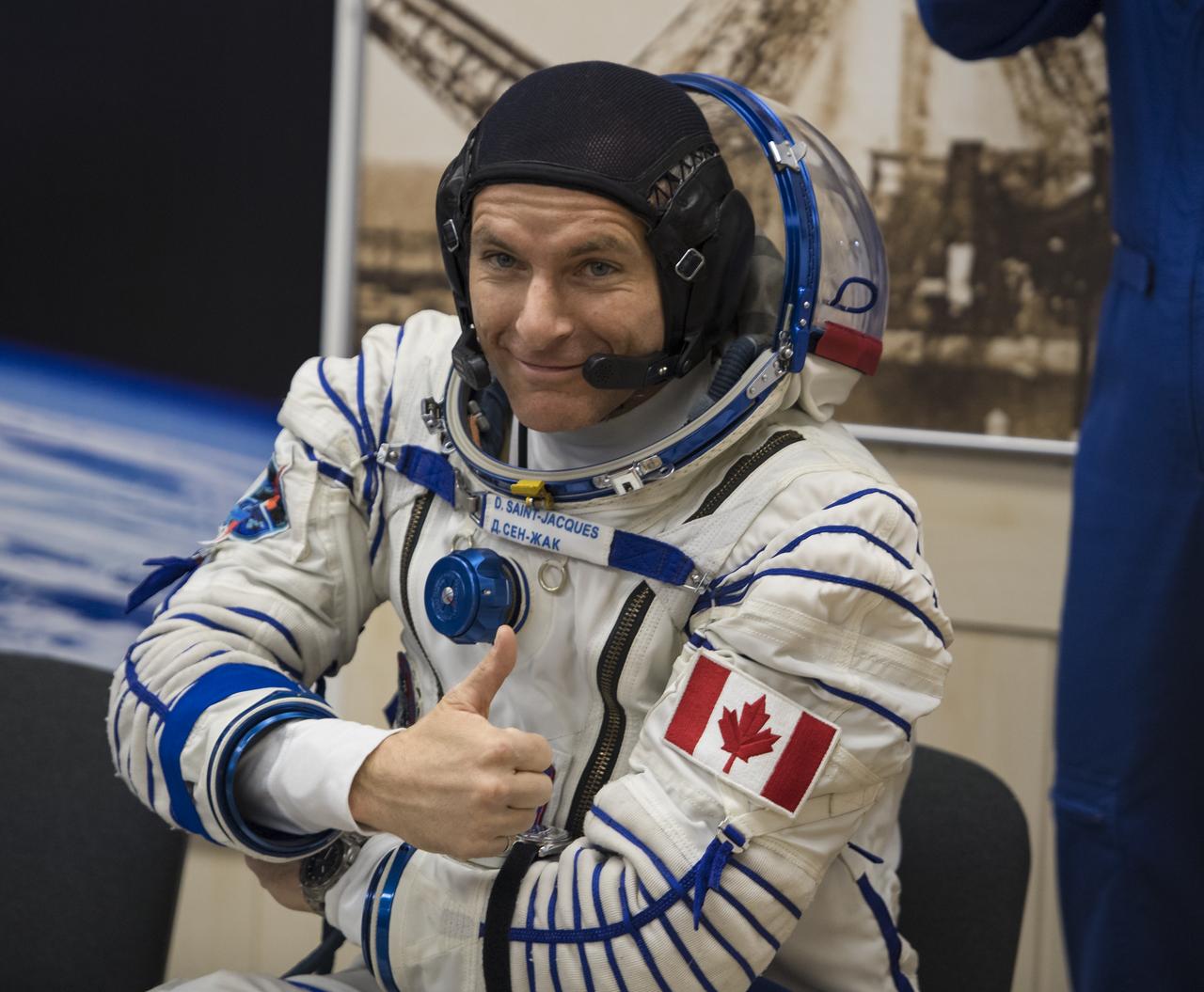 Expedition 58 Flight Engineer David Saint-Jacques of the Canadian Space Agency (CSA) poses for a photo while he waits to have his Russian Sokol suit pressure checked in preparation for his launch aboard the Soyuz MS-11 spacecraft on Monday, Dec. 3, 2018, at the Baikonur Cosmodrome in Kazakhstan. Launch of the Soyuz rocket is scheduled for the same day and will carry Saint-Jacques, Flight Engineer Anne McClain of NASA, and Soyuz Commander Oleg Kononenko of Roscosmos into orbit to begin their six and a half month mission on the International Space Station. Photo Credit: (NASA/Aubrey Gemignani)