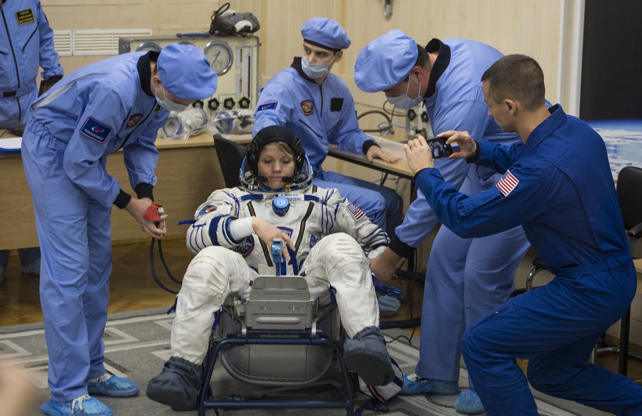 Expedition 58 Flight Engineer Anne McClain of NASA has her Russian Sokol suit pressure checked in preparation for her launch aboard the Soyuz MS-11 spacecraft on Monday, Dec. 3, 2018, at the Baikonur Cosmodrome in Kazakhstan. Launch of the Soyuz rocket is scheduled for the same day and will carry McClain, Soyuz Commander Oleg Kononenko of Roscosmos, and Flight Engineer David Saint-Jacques of the Canadian Space Agency (CSA) into orbit to begin their six and a half month mission on the International Space Station. Photo Credit: (NASA/Aubrey Gemignani)