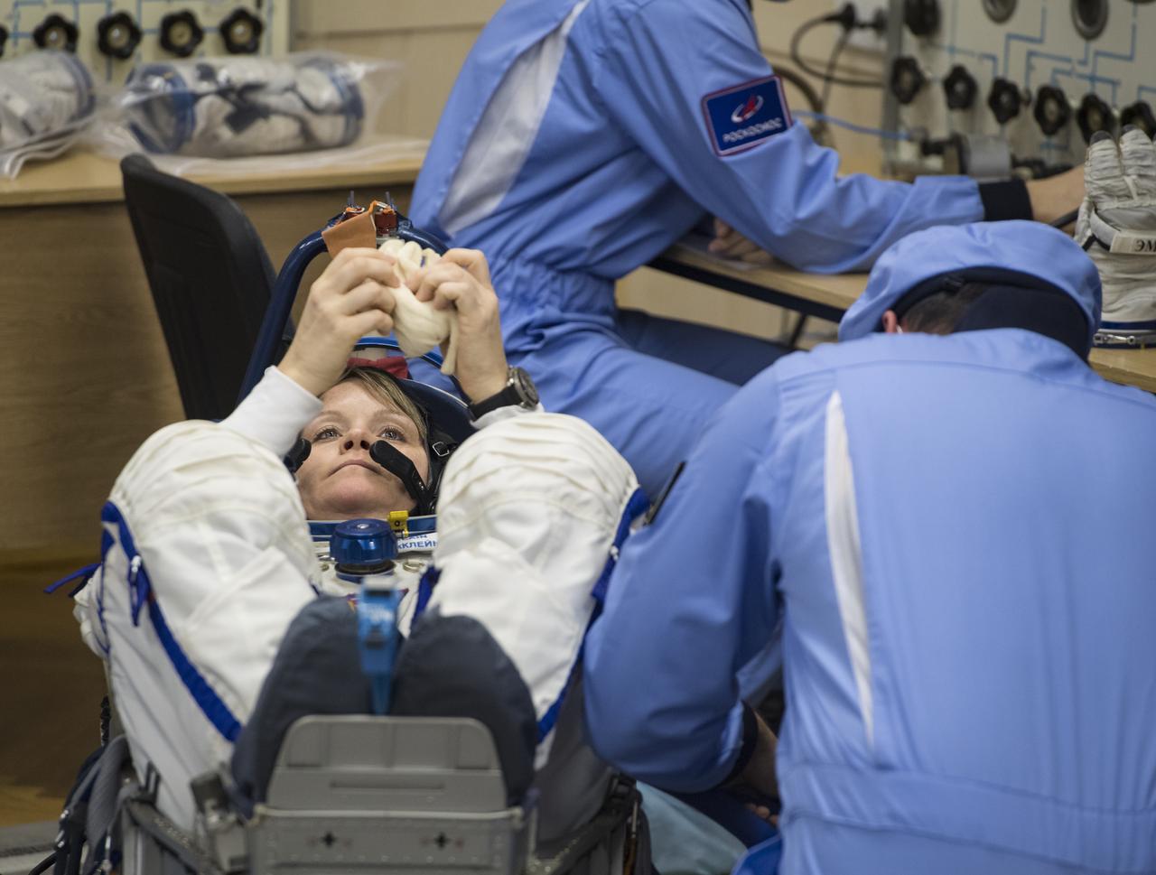 Expedition 58 Flight Engineer Anne McClain of NASA has her Russian Sokol suit pressure checked in preparation for her launch aboard the Soyuz MS-11 spacecraft on Monday, Dec. 3, 2018, at the Baikonur Cosmodrome in Kazakhstan. Launch of the Soyuz rocket is scheduled for the same day and will carry McClain, Soyuz Commander Oleg Kononenko of Roscosmos, and Flight Engineer David Saint-Jacques of the Canadian Space Agency (CSA) into orbit to begin their six and a half month mission on the International Space Station. Photo Credit: (NASA/Aubrey Gemignani)