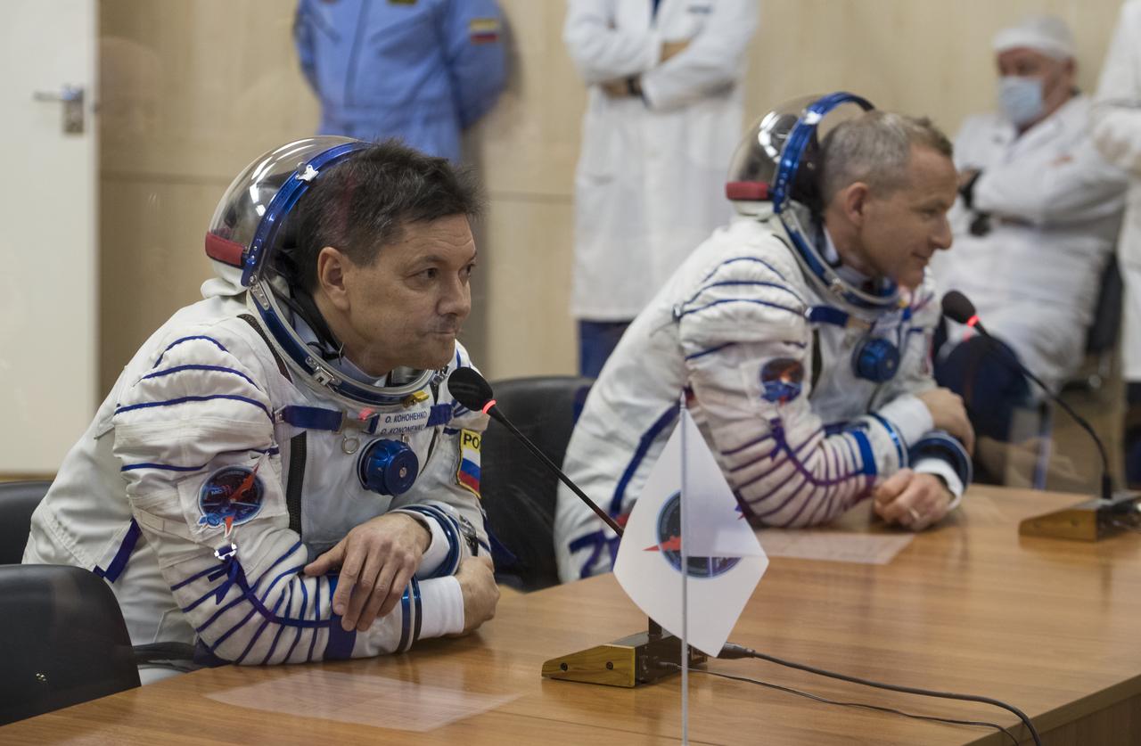 Expedition 58 Soyuz Commander Oleg Kononenko of Roscosmos, left, and Flight Engineer David Saint-Jacques of the Canadian Space Agency (CSA) speak to family and friends after having their Russian Sokol suits pressure checked in preparation for their launch aboard the Soyuz MS-11 spacecraft on Monday, Dec. 3, 2018, at the Baikonur Cosmodrome in Kazakhstan. Launch of the Soyuz rocket is scheduled for the same day and will carry Kononenko, Saint-Jacques, and Flight Engineer Anne McClain of NASA into orbit to begin their six and a half month mission on the International Space Station. Photo Credit: (NASA/Aubrey Gemignani)