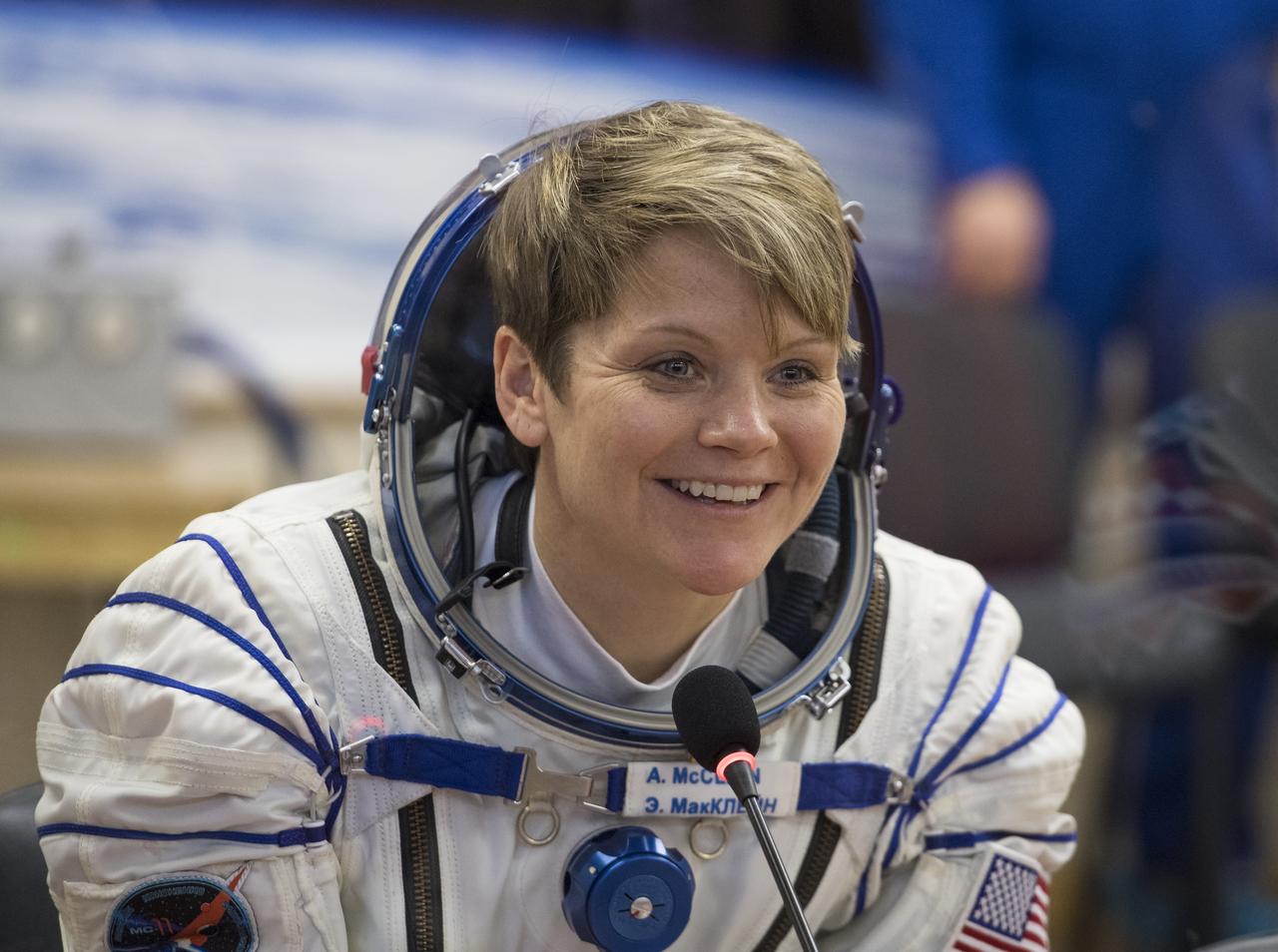 Expedition 58 Flight Engineer Anne McClain of NASA speaks with friends and family after having her Russian Sokol suit pressure checked in preparation for her launch aboard the Soyuz MS-11 spacecraft on Monday, Dec. 3, 2018, at the Baikonur Cosmodrome in Kazakhstan. Launch of the Soyuz rocket is scheduled for the same day and will carry McClain, Soyuz Commander Oleg Kononenko of Roscosmos, and Flight Engineer David Saint-Jacques of the Canadian Space Agency (CSA) into orbit to begin their six and a half month mission on the International Space Station. Photo Credit: (NASA/Aubrey Gemignani)
