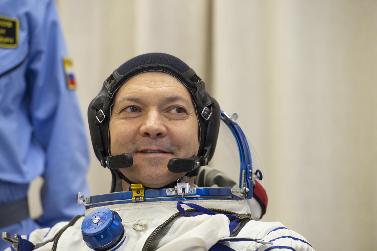 Expedition 58 Soyuz Commander Oleg Kononenko of Roscosmos is helped into his Russian Sokol suit as he and fellow crewmates, Flight Engineer Anne McClain of NASA and Flight Engineer David Saint-Jacques of the Canadian Space Agency (CSA) prepare for their Soyuz launch to the International Space Station, on Monday, Dec. 3, 2018 at the Baikonur Cosmodrome in Kazakhstan. Launch of the Soyuz rocket is scheduled for the same day and will carry Kononenko, McClain, and Saint-Jacques into orbit to begin their six and a half month mission on the International Space Station. Photo Credit: (GCTC/NASA/Andrey Shelepin)