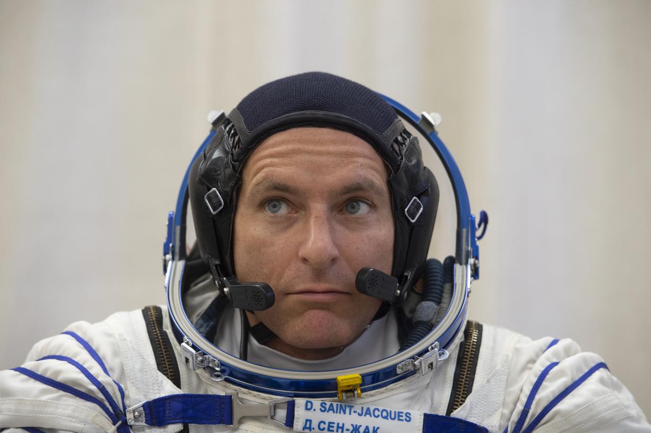 Expedition 58 Flight Engineer David Saint-Jacques of the Canadian Space Agency (CSA) is seen after being helped into his Russian Sokol suit as he and fellow crewmates, Soyuz Commander Oleg Kononenko of Roscosmos, and Flight Engineer Anne McClain of NASA prepare for their Soyuz launch to the International Space Station, on Monday, Dec. 3, 2018 at the Baikonur Cosmodrome in Kazakhstan. Launch of the Soyuz rocket is scheduled for the same day and will carry Saint-Jacques, Kononenko, and McClain into orbit to begin their six and a half month mission on the International Space Station. Photo Credit: (GCTC/NASA/Andrey Shelepin)
