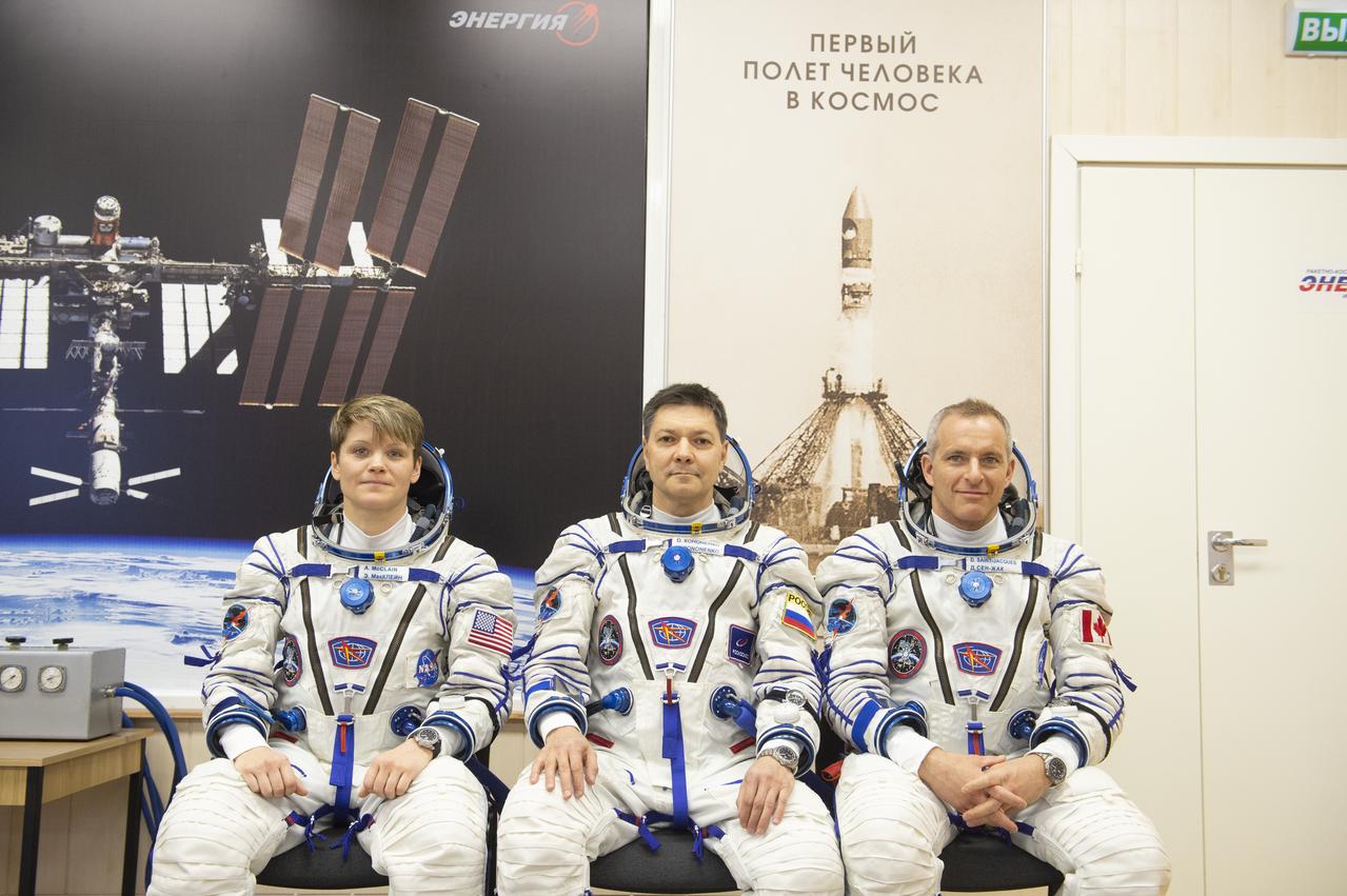 Expedition 58 crew, from left to right, Flight Engineer Anne McClain of NASA, Soyuz Commander Oleg Kononenko of Roscosmos, and Flight Engineer David Saint-Jacques of the Canadian Space Agency (CSA) are seen just after being helped into their Russian Sokol suits in Baikonur, Kazakhstan. Launch of the Soyuz rocket is scheduled for the same day and will carry McClain, Kononenko, and Saint-Jacques into orbit to begin their six and a half month mission on the International Space Station. Photo Credit: ((GCTC/NASA/Andrey Shelepin))