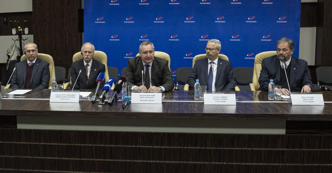 Dmitry Rogozin, the head of Roscosmos, center, discusses the successful launch and docking of the Expedition 58 crew to the International Space Station during a post-docking news conference with NASA’s Associate Administrator for Human Exploration Operations, William Gerstenmaier, left of Rogozin, and Sylvain Laporte, president, Canadian Space Agency (CSA), right of Rogozin, Dec. 4 in Baikonur, Kazakhstan. At the news conference, Rogozin announced that NASA astronaut Nick Hague and Roscosmos cosmonaut Alexey Ovchinin, who were involved in the abort of their first launch Oct. 11, would be reflown on Feb. 28, along with NASA astronaut Christina Koch as the Expedition 59-60 crew. Photo Credit: (NASA/Aubrey Gemignani)