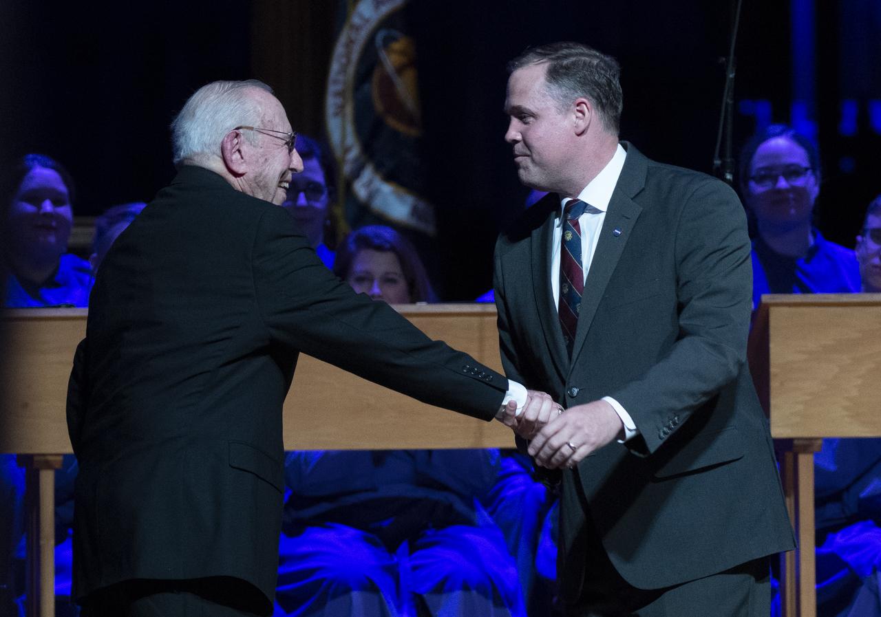 Apollo 8 astronaut Jim Lovell shakes hands with NASA Administrator Jim Bridenstine after being introduced during the Smithsonian National Air and Space Museum's Spirit of Apollo event commemorating the 50th anniversary of Apollo 8, Tuesday, Dec. 11, 2018 at the Washington National Cathedral in Washington, DC. Apollo 8 was humanity's first journey to another world, taking astronauts Frank Borman, Jim Lovell, and William Anders to the Moon and back in December of 1968. Photo Credit: (NASA/Joel Kowsky)