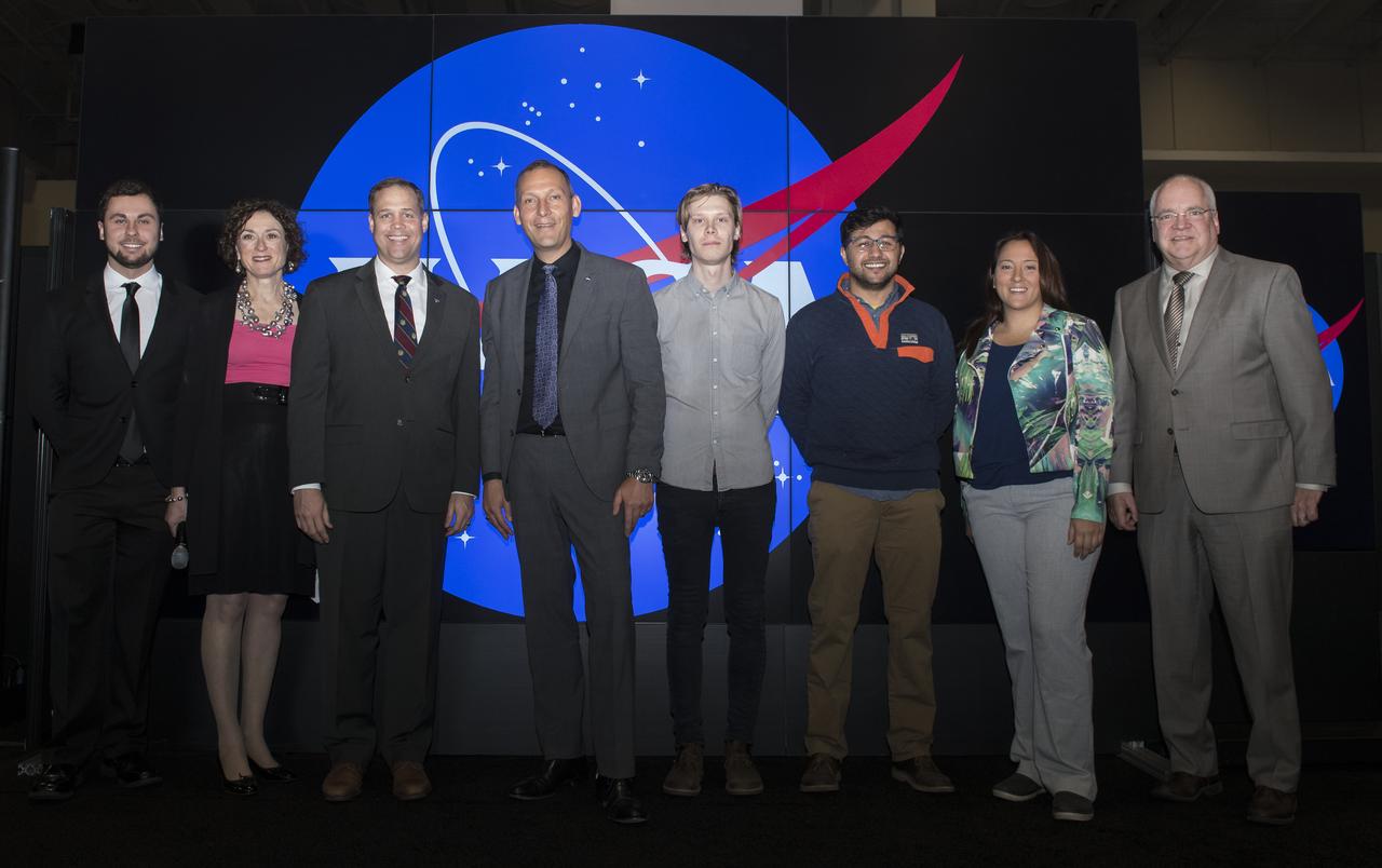 Christine McEntee, American Geophysical Union (AGU) Executive Director and Chief Executive Officer, second from left; NASA Administrator Jim Bridenstine, third from left; Thomas Zurbuchen, associate administrator, Science Mission Directorate, NASA, fourth from left; and Dennis Andrucyk, deputy associate administrator, Science Mission Directorate, NASA, right, pose for a photo with winners of the AGU Data Visualization Storytelling Competition at the annual AGU meeting, Tuesday, Dec. 11, 2018 at the Washington Convention Center in Washington. Photo Credit: (NASA/Aubrey Gemignani)