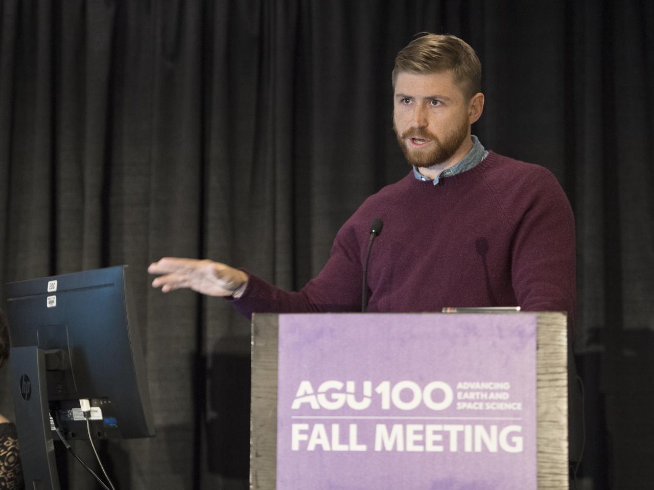 Casey Youngflesh speaks during the press briefing, "Penguins from Space", Tuesday, December 11, 2018 at the Marriott Marquis in Washington as part of the American Geophysical Union (AGU) annual meeting. Photo Credit: (NASA/Aubrey Gemignani)