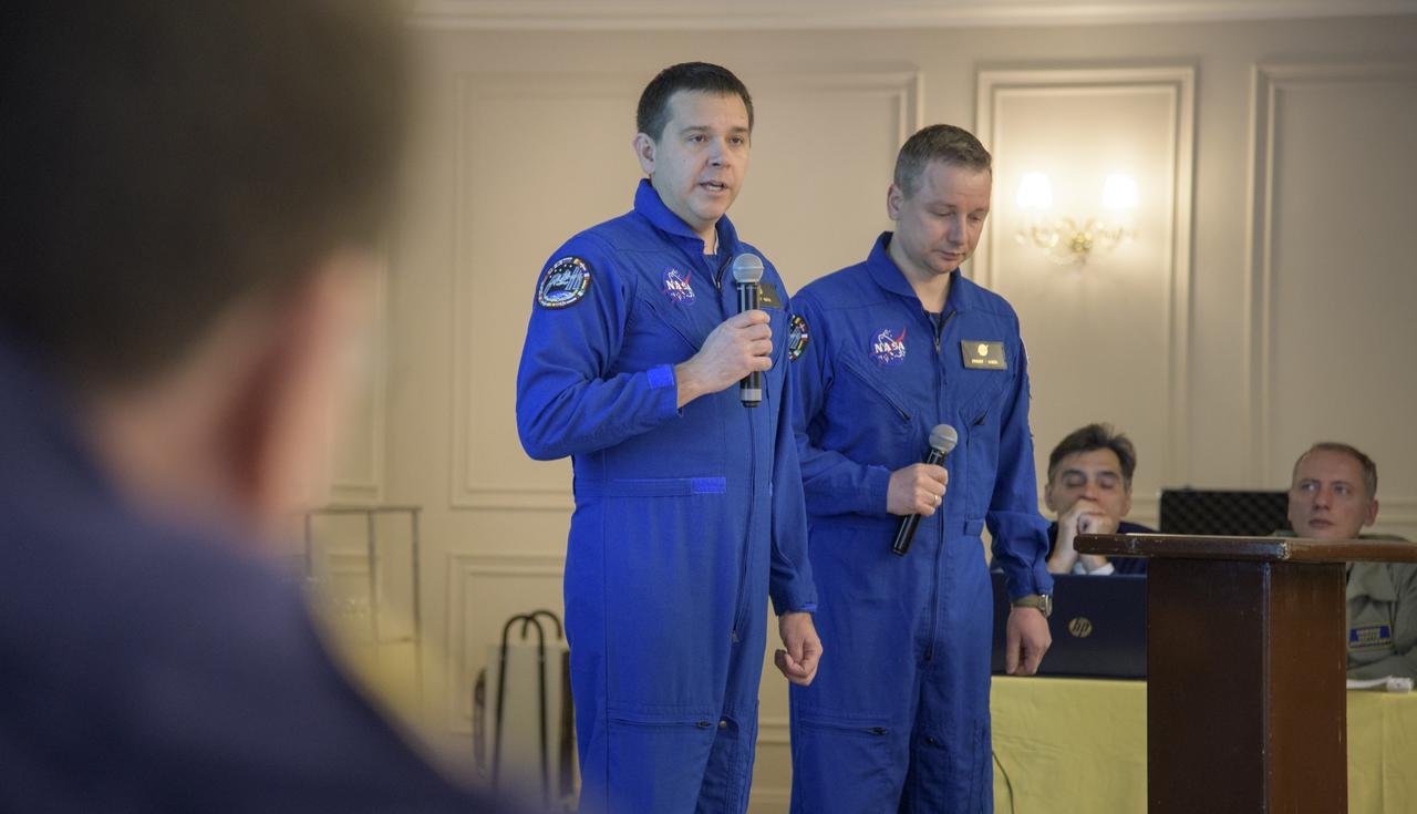 NASA Director for Human Space Flight Programs, Russia, Chad Rowe, left, with the support of NASA Interpreter Evgeny Sokol, delivers his report during a meeting to discuss the readiness for the landing of Expedition 57 crew members Serena Auñón-Chancellor of NASA, Alexander Gerst of ESA (European Space Agency), and Sergey Prokopyev of Roscosmos, Tuesday, Dec. 18, 2018. Auñón-Chancellor, Gerst, and Prokopyev are returning after 197 days in space where they served as members of the Expedition 56 and 57 crews onboard the International Space Station. Photo Credit: (NASA/Bill Ingalls)