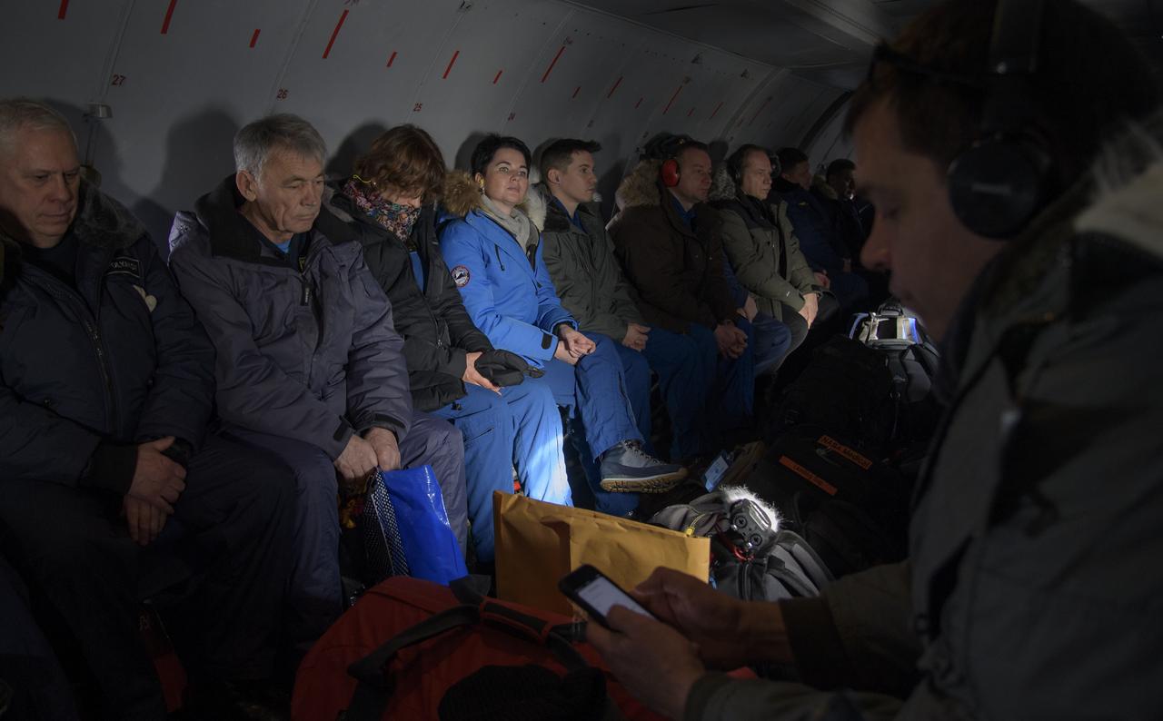 NASA, ESA, Roscosmos, and Russian Search and Recovery Forces are seen onboard a AN-26 aircraft as they deploy from Karaganda to Zhezkazgan, Kazakhstan in advance of the landing of Expedition 57 crew members Serena Auñón-Chancellor of NASA, Alexander Gerst of ESA (European Space Agency), and Sergey Prokopyev of Roscosmos. Wednesday, Dec. 19, 2018. Auñón-Chancellor, Gerst, and Prokopyev are returning after 197 days in space where they served as members of the Expedition 56 and 57 crews onboard the International Space Station. Photo Credit: (NASA/Bill Ingalls)