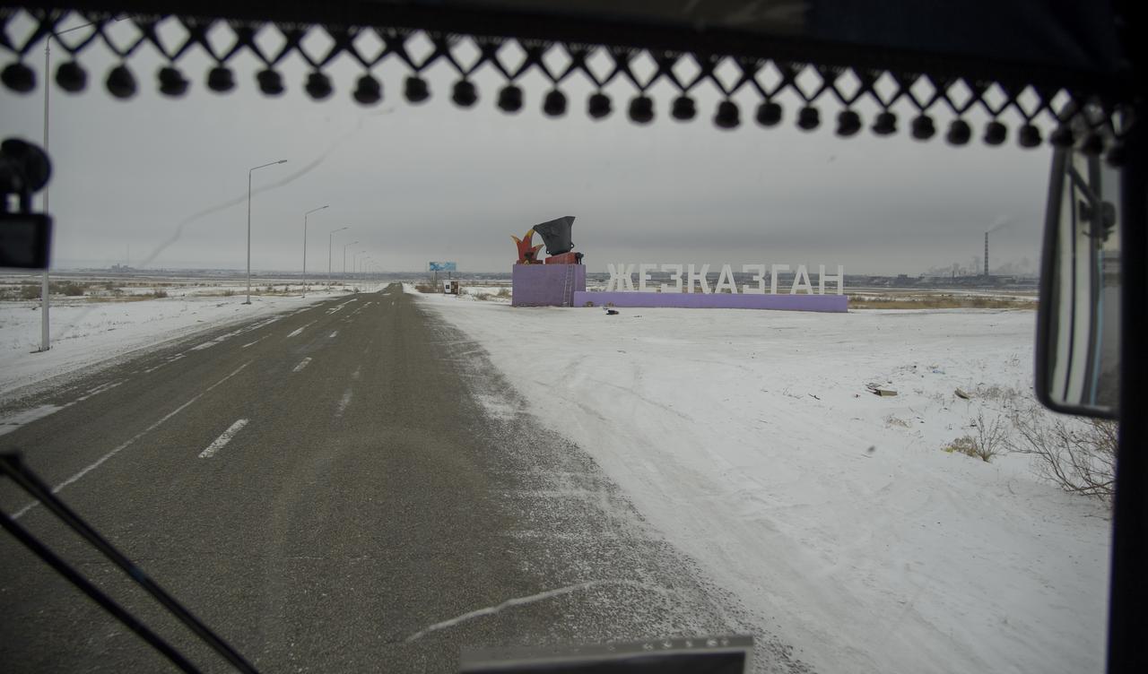 View from the bus carrying team members from NASA, ESA, Roscosmos, and Russian Search and Recovery Forces drive as they drive into Zhezkazgan, Kazakhstan in advance of the landing of Expedition 57 crew members Serena Auñón-Chancellor of NASA, Alexander Gerst of ESA (European Space Agency), and Sergey Prokopyev of Roscosmos. Wednesday, Dec. 19, 2018. Auñón-Chancellor, Gerst, and Prokopyev are returning after 197 days in space where they served as members of the Expedition 56 and 57 crews onboard the International Space Station. Photo Credit: (NASA/Bill Ingalls)