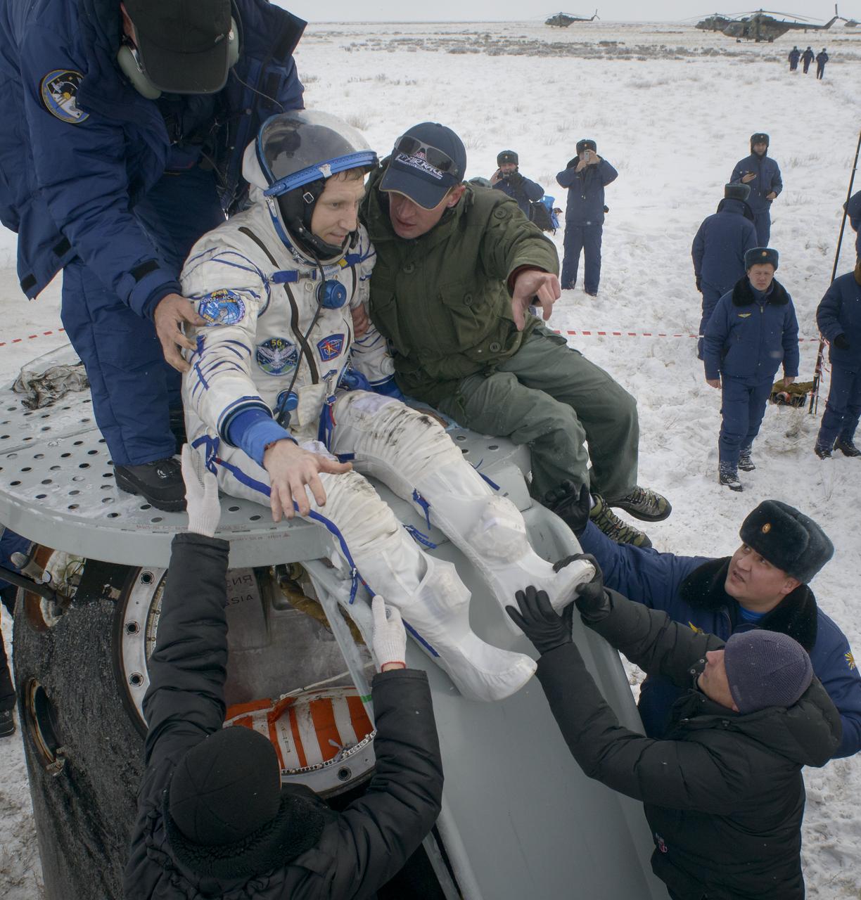 Sergey Prokopyev of Roscosmos is helped out of the Soyuz MS-09 spacecraft just minutes after he, Serena Auñón-Chancellor of NASA, and Alexander Gerst of ESA (European Space Agency) landed in a remote area near the town of Zhezkazgan, Kazakhstan on Thursday, Dec. 20, 2018. Auñón-Chancellor, Gerst, and Prokopyev are returning after 197 days in space where they served as members of the Expedition 56 and 57 crews onboard the International Space Station. Photo Credit: (NASA/Bill Ingalls)