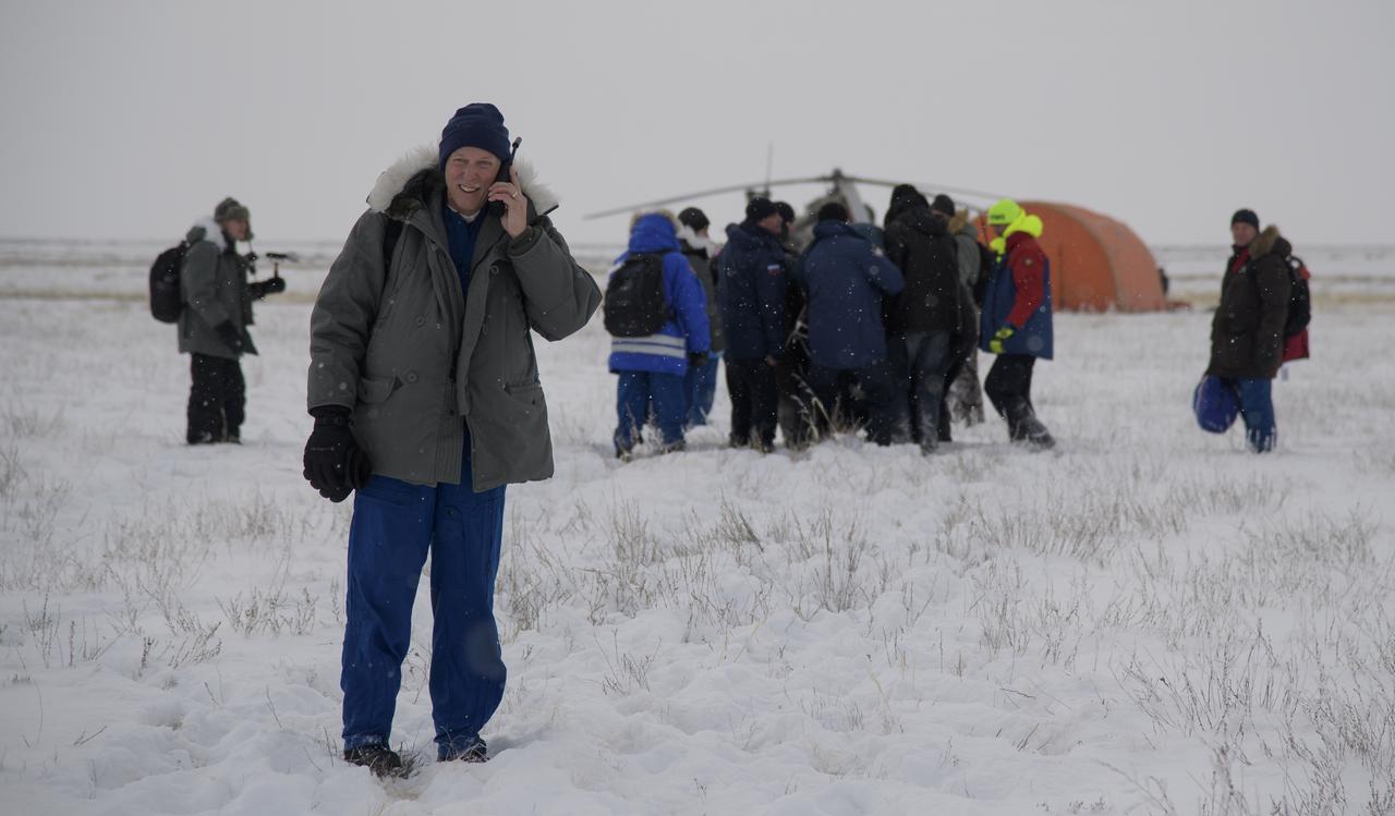 NASA International Space Station Operations Integration Manager Kenny Todd talks to NASA teams back in Houston as Serena Auñón-Chancellor of NASA is carried to a medical tent shortly after she, Alexander Gerst of ESA (European Space Agency), and Sergey Prokopyev of Roscosmos landed in their Soyuz MS-09 spacecraft near the town of Zhezkazgan, Kazakhstan on Thursday, Dec. 20, 2018. Auñón-Chancellor, Gerst, and Prokopyev are returning after 197 days in space where they served as members of the Expedition 56 and 57 crews onboard the International Space Station. Photo Credit: (NASA/Bill Ingalls)