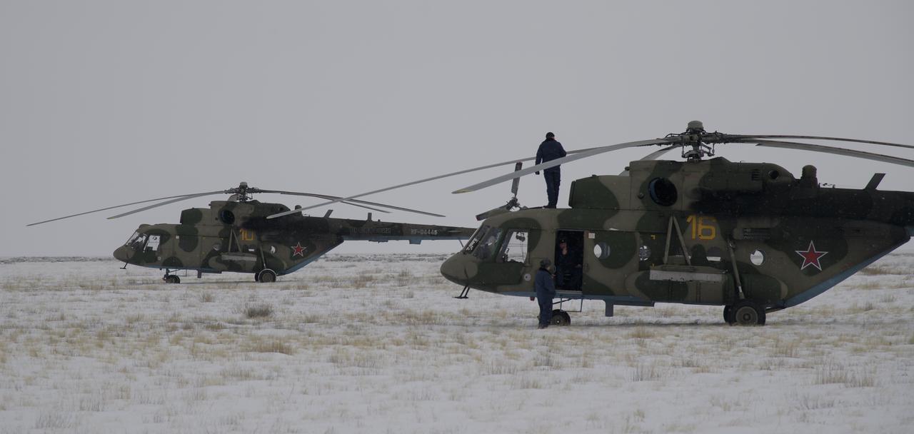 Russian Search and Rescue helicopters are parked near the Soyuz MS-09 spacecraft shortly after it landed with Expedition 57 crew members Serena Auñón-Chancellor of NASA, Alexander Gerst of ESA (European Space Agency), and Sergey Prokopyev of Roscosmos near the town of Zhezkazgan, Kazakhstan on Thursday, Dec. 20, 2018. Auñón-Chancellor, Gerst, and Prokopyev are returning after 197 days in space where they served as members of the Expedition 56 and 57 crews onboard the International Space Station. Photo Credit: (NASA/Bill Ingalls)