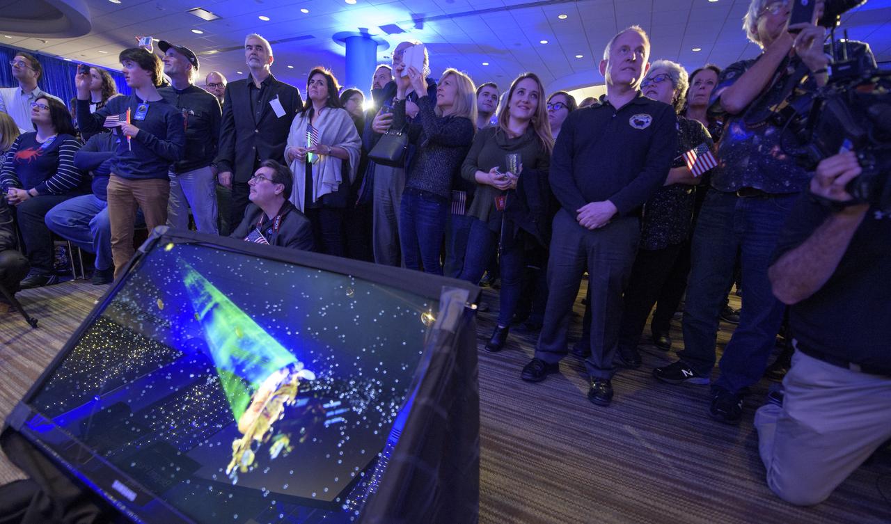 New Horizons principal investigator Alan Stern of the Southwest Research Institute (SwRI), Boulder, CO, right, along with other mission team members and guest watch as Brian May, lead guitarist of the rock band Queen and astrophysicist shows a video with a new song he wrote for the New Horizons mission, Tuesday, Jan. 1, 2019 at Johns Hopkins University Applied Physics Laboratory (APL) in Laurel, Maryland. Photo Credit: (NASA/Bill Ingalls)