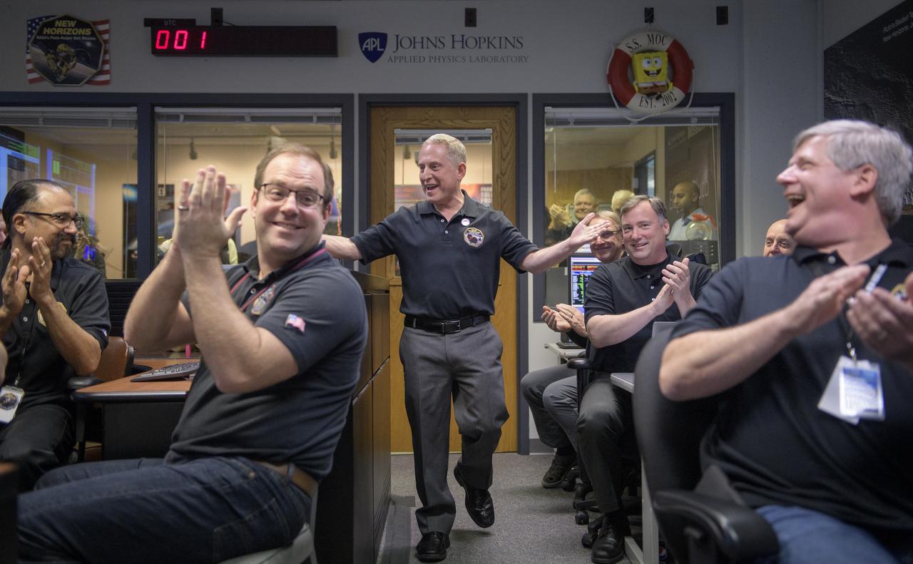 New Horizons principal investigator Alan Stern of the Southwest Research Institute (SwRI), Boulder, CO, celebrates with other mission team members after they received signals from the spacecraft that it is healthy and collected data during the flyby of Ultima Thule, Tuesday, Jan. 1, 2019 at the Mission Operations Center of the Johns Hopkins University Applied Physics Laboratory (APL) in Laurel, Maryland. Photo Credit: (NASA/Bill Ingalls)