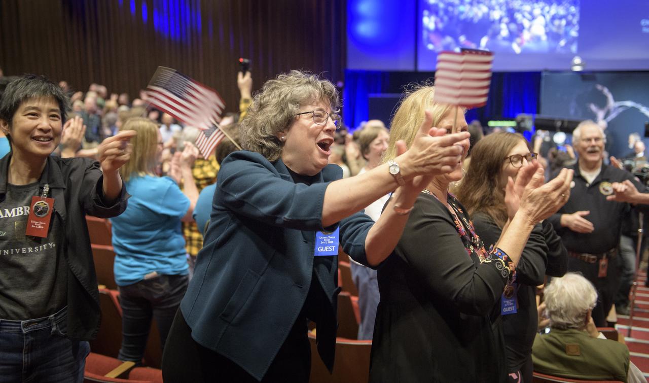 Guests congratulate New Horizons team members after they received signals from the New Horizons spacecraft that it is healthy and it collected data during the fly of Ultima Thule, Tuesday, Jan. 1, 2019 at Johns Hopkins University Applied Physics Laboratory (APL) in Laurel, Maryland. Photo Credit: (NASA/Bill Ingalls)